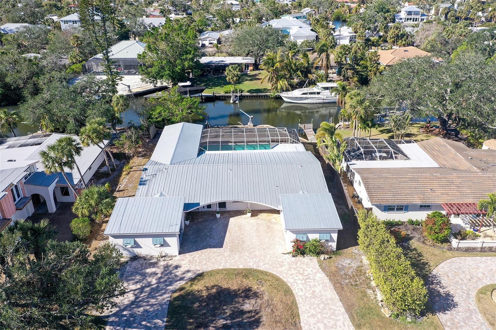 Discover the rare opportunity to build or renovate on an exceptional .36-acre canal-front property located in the sought-after Sara Sands neighborhood on Siesta Key. Tucked away in a serene, upscale enclave just moments from the vibrant Siesta Key Village and the world-renowned Siesta Key Beach, this property offers the perfect blend of tranquility and convenience. The existing home—professionally remediated after flood damage—presents a unique opportunity for those looking to reimagine or completely rebuild. With ideal north-south exposure, this lot provides the perfect canvas for creating a custom-designed retreat that captures the coastal lifestyle. Boating enthusiasts will appreciate the private dock on a wide, deep-water canal, granting effortless access to the scenic Grand Canal and the Intracoastal Waterway. Whether you envision peaceful mornings on the water, lively gatherings by the pool, or simply relaxing in your personal oasis, the possibilities are endless. 5072 Higel Avenue is more than just a homesite—it's a lifestyle destination. Walk or bike to the #1 beach in the USA, then return to your private paradise. Enjoy world-class boating, fishing, fine dining, boutique shopping, and the cultural offerings of downtown Sarasota—all just minutes away. Bring your contractors, your architect, and your vision. This is your chance to create something truly special in one of Siesta Key’s most desirable locations. Don’t miss this exceptional opportunity. Schedule your private showing today.