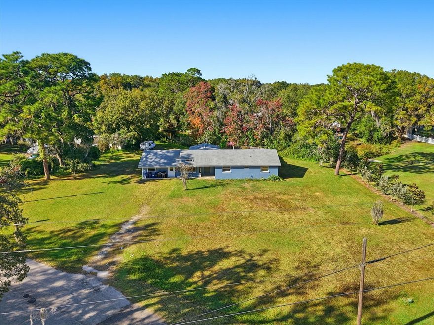 Welcome to a rare Florida find where vintage charm meets modern comfort. This beautifully maintained cottage sits on a private oversized lot and offers nearly 2,300 sq ft of flexible living space.
Inside, ceramic tile floors connect an open layout with a spacious living room, dining area, and office. Storm windows fill the home with natural light, and the kitchen features solid cabinetry and plenty of room to cook and entertain.
The main-floor primary bedroom includes a built-in closet and soft carpeting. Two additional bedrooms allow for space for guests or hobbies, and an 18x16 workshop adds even more versatility.
Step outside to your private oasis: a large patio, sparkling saltwater pool with child safety fence, and peaceful wooded views along 80 feet of waterfront on Red Bug Lake—perfect for kayaking, paddleboarding, or relaxing by the water.
A converted garage, storage shed, and generous driveway add convenience. With sturdy block construction, a shingle roof, and no HOA, CDD, or lease restrictions, this home gives you freedom and long-lasting value.