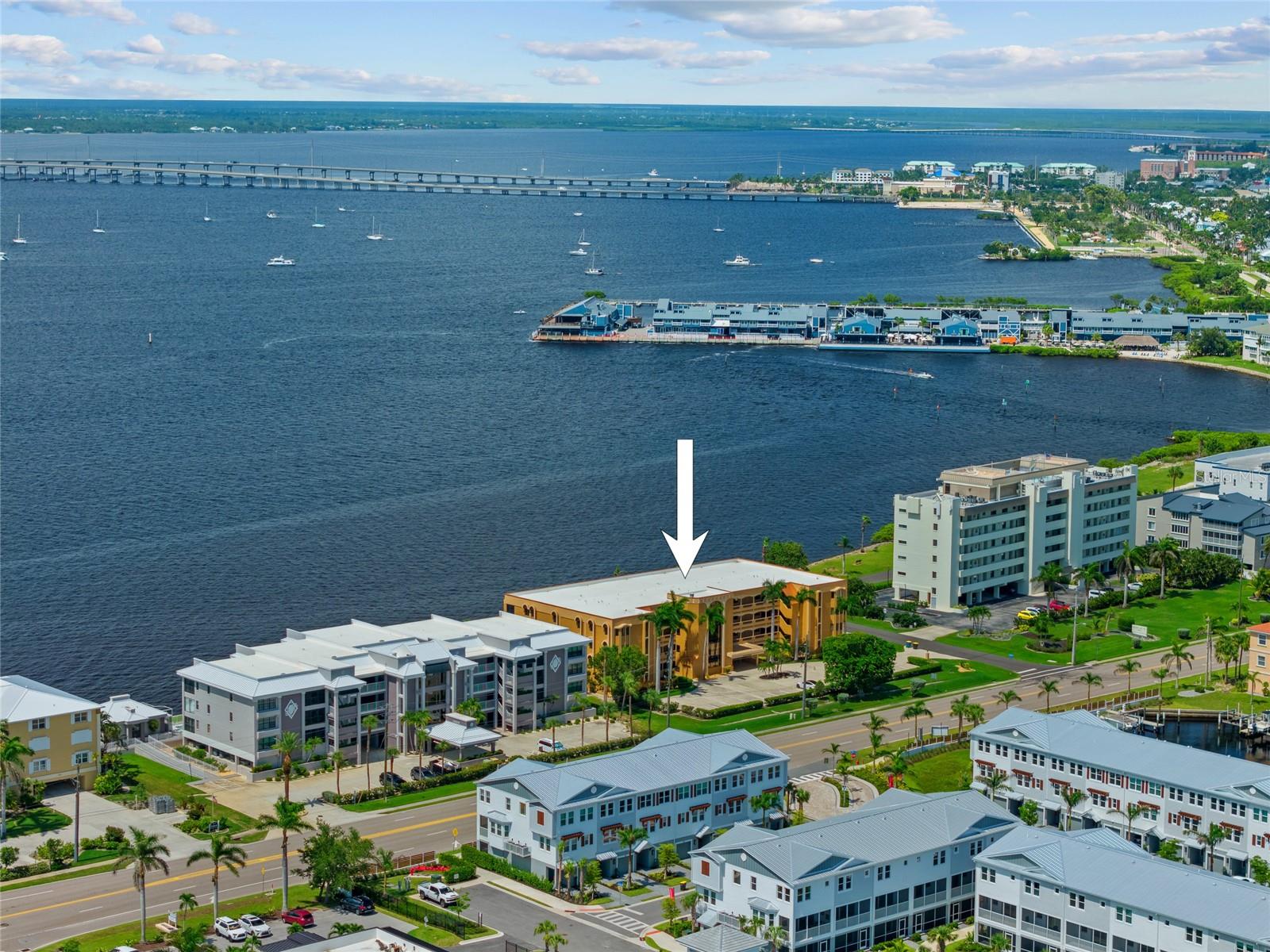 PRIME WATERFRONT LOCATION! WELL MAINTAINED 2 BEDROOM PLUS DEN, 2 BATH WATERFRONT CONDO IN PUNTA GORDA ISLES! Front entry opens into hall leading into newly remodeled kitchen featuring cherry cappuccino wood cabinetry, quartz countertops, tile backsplash, stainless steel appliances and breakfast bar perfect for hosting and entertaining. The great room/living and dining room opens up with large sliders to 28 foot screened lanai with full length hurricane shutters for protection. Generous primary bedroom offers walk-in closet with ensuite bath featuring dual sink vanity and walk-in shower. Nicely sized guest bedroom and guest bath. Bonus features include inside laundry room, smart thermostat, office/ den plumbed for wet bar, trash shoot, designated parking space, personal storage unit #4, and breathtaking unobstructed water views—perfect for simply soaking in the beautiful surroundings. Popular golf and boating community within easy walking or biking distance to the Yacht Club, Fishermen’s Village, Harbor Walk and close to St. Andrews South Golf Club and the historic downtown area of Punta Gorda. Enjoy quick access to arts, community events, entertainment, world-class fishing, boating, fine dining, tennis, pickleball and beautiful parks. A short drive to Florida's Gulf coast most beautiful beaches in the US/world. Don't miss your chance to own this waterfront treasure! Schedule your private showing today!