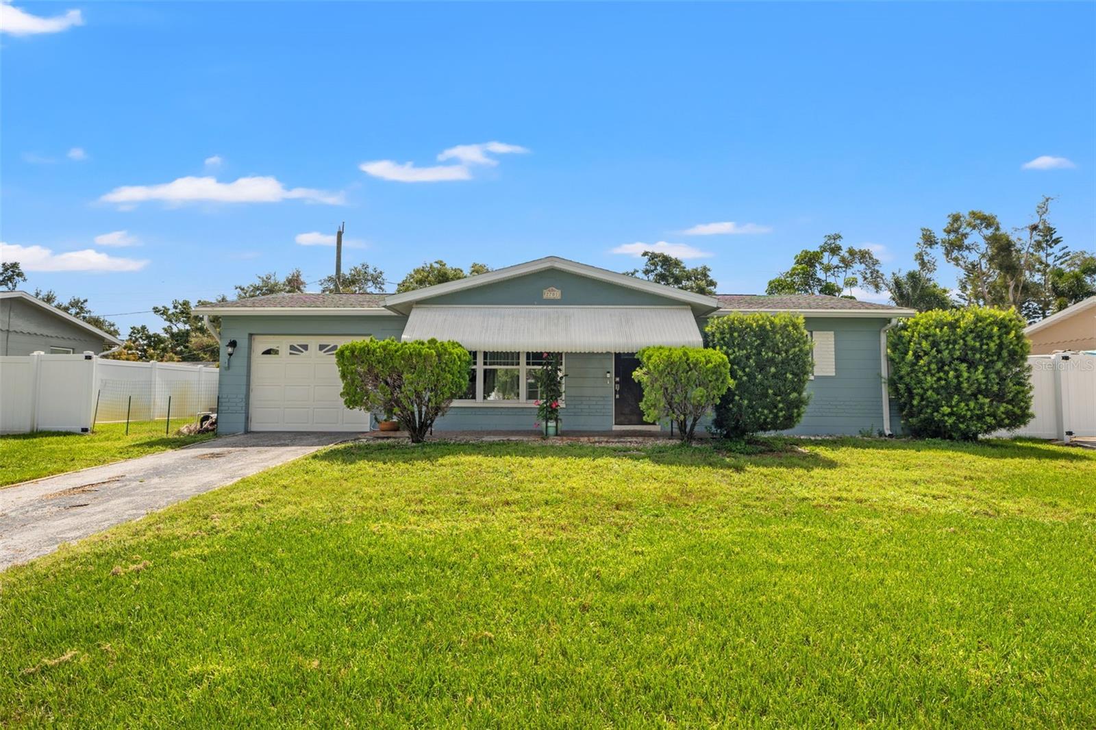 Welcome home to ideal Florida living with this 1960 block home nestled in the Disston Heights neighborhood. You enter the home to an inviting living room with beautiful ceramic hardwood floors. Beyond the living room is the updated eat-in kitchen with granite countertops, LG stainless steel appliances and plenty of storage. Off the kitchen is a convenient one car attached garage with plenty of storage and laundry. To the east of the home are two well appointed bedrooms with ample storage and a nicely updated shared bathroom with a Woodbridge bidet. At the rear of the home off the kitchen is a peaceful sun-drenched Florida room overlooking a stunning backyard with its own POOL. This outdoor oasis boasts patio pavers, newer privacy fencing, gorgeous landscaping, green space for your furry friends and your own bar equipped with a kegerator to properly entertain family and friends. Don't miss out on owning this one of a kind Florida living home.