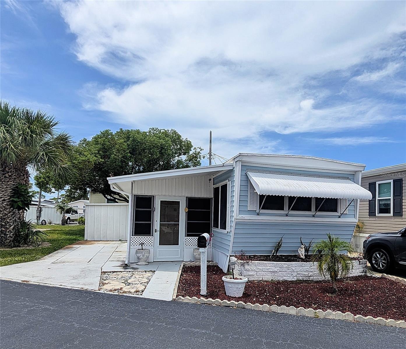Are you looking for an AFFORDABLE retro mobile home in a GREAT location?! This 1 bedroom/ 1 bath home has many nice features to enjoy! The spacious bedroom will fit a king size bed and offers 3 closets and a built in dresser & desk. The bathroom is also roomy and offers a double vanity with a tub/ shower. The 20' x 8' screened lanai extends your living space and can act as a secondary living area. It leads to a covered workshop and laundry room (featuring a full size washer & dryer) and provides access to a 10' x 8' shed. This opportunity is perfect for anyone 55 and over who is looking for a primary home or someone wanting a vacation home near the beaches! Located only 4 miles to the sand and near a multitude of shops and restaurants, this location can't be beat! Within minutes you can be biking the Pinellas Trail, shopping at Tyrone Mall, walking your furry friend or swimming in the pool at Walter Fuller Park (located directly across the street)! Eagles Nest has NO land lease fee and is a cooperative that brags a low monthly HOA fee of only $177/month. This includes water, sewer, trash and lawn maintenance! Pet friendly for 2 furry friends at 30 lbs each. Being sold furnished and "as is" for the convenience of the Seller. This price includes the share!
