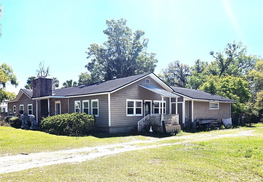 NOW, this is an amazing opportunity! If you are looking for SPACE well then look no further! Bring the whole family, even the in-laws! Do you have TOYS, bring those too! Situated over an acre, this home features a large swimming pool for family gatherings or lazy afternoons. No HOA fees. Original wood floors. Newer Roof replaced in 2018. Great room contains a wood burning fireplace for cozy evenings. The primary bedroom has an Ensuite plus a large walk-in closet and pocket doors. The kitchen features an open style layout with wood cabinets. Plus, walk outside into a separate workshop that's included with the property with an additional 1,260 sq ft. with its own kitchenette, bedroom and bathroom all included as a great In Law Suite and large attached workshop or garages. Located in quaint Orange City it needs some love but with some TLC the potential is endless. Easy Access to I-4 then west to Orlando attractions or east to the Rivers and Beaches. Come enjoy yourself and make this your own one-of-a-kind gem with space and entertainment for all!