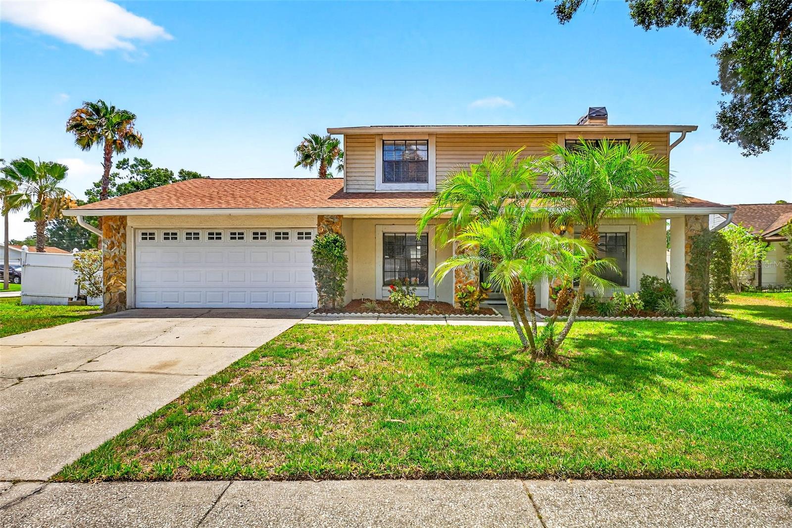 Discover this beautiful pool, home situated on a desirable corner lot in Country Place West! This inviting two-story residence features 3 bedrooms, 2.5 baths, separate formal living and dining rooms, and a spacious, functional kitchen and family room combination. Tastefully updated with LifeProof laminate flooring across most of the main level, the home boasts a newly remodeled, cook-friendly kitchen with PAINTED CABINETS (2025) and BRAND NEW MATCHING GE APPLIANCES—including refrigerator, dishwasher, range, and microwave (2025)—with a transferrable warranty for peace of mind. The light-filled family room includes a cozy wood-burning fireplace and sliding doors that lead directly to the screened lanai and pool area, complete with a pool fence for added safety and a convenient downstairs half-bath/pool bath. Upstairs, you'll find a cozy landing with a built-in bookcase, leading to three well-sized bedrooms. The two secondary bedrooms are connected by a Jack-and-Jill bathroom, each with its own sink vanity, while the spacious primary suite offers His and Hers closets, a dual-sink vanity, and a large window that fills the room with natural light. Recent upgrades include a new ROOF (2025), POOL HEATER (2025), VINYL DOUBLE DOOR GATE (2025), and PARTIAL WOOD FENCE REPLACEMENT (2025). The fully fenced backyard offers ample room to relax or entertain and includes a side gate for easy boat or trailer storage. With a low HOA fee, residents enjoy access to community parks, playgrounds, sports fields, and courts for tennis, basketball, and racquetball. Country Place West is zoned for great schools and ideally located near shopping, dining, Citrus Park Mall, the Upper Tampa Bay Trail, and the Veterans Expressway, this move-in-ready home offers the perfect blend of comfort, updates, and unbeatable location. Don’t miss out!