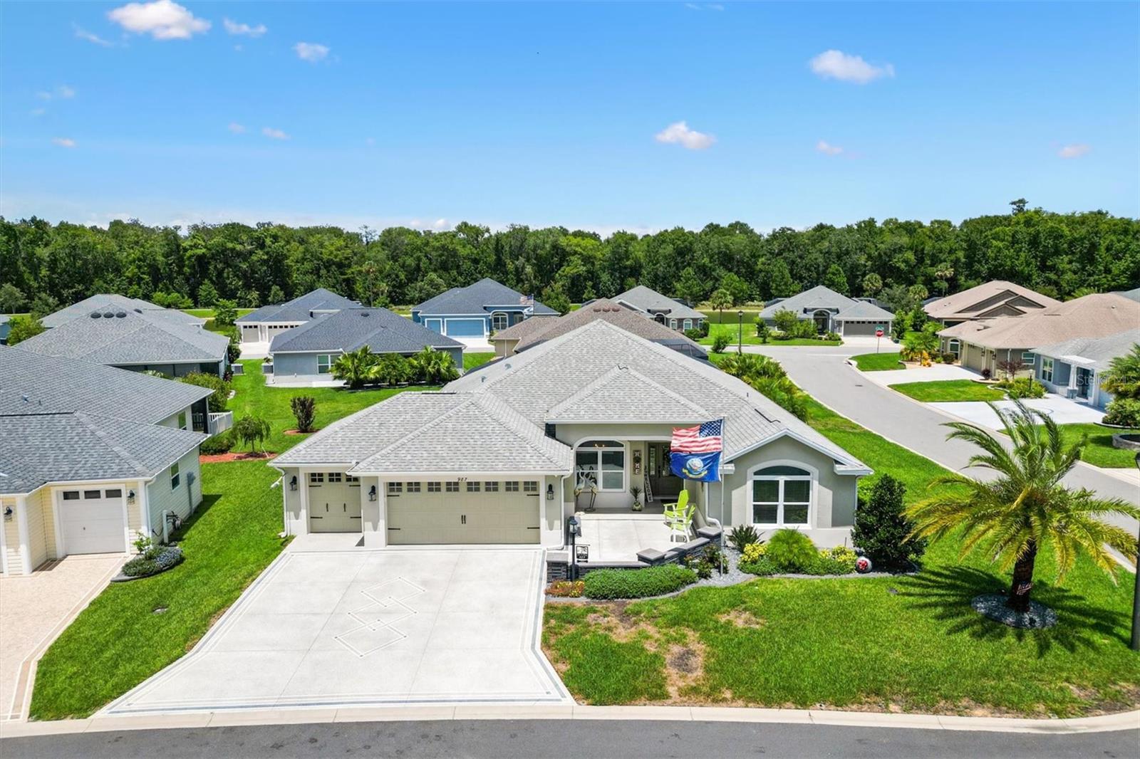 Welcome to 987 Frederick Terrace, an exquisite Three Bedroom, Two Bathroom, Pool home, built in 2020, with approximately 2060 Square Feet of Living Space, located in the Village of Bradford in The Villages. This beautiful modern Designer Home features a split floor plan, and a spacious and open Living Room/Dining Room, leading to a truly spectacular private Outdoor Oasis. There is an inviting Heated Pool and Spa in this Extended Outdoor Space, with an Enclosed Screened Lanai, surrounded by Lush Tropical Landscaping, making the outdoor living space very private., with relaxing lounge areas, perfect for entertaining family and friends! The Primary Bedroom has a Tray Ceiling, with Two Custom Walk-In Closets, and an En Suite Bathroom with a Tiled Floor, private Toilet Room and a Roman Shower. There is a privacy pocket door leading to the Guest Bedrooms, which share an Upgraded Bathroom with Maple Cabinets, Quartz Counters, Tiled Floor and Tiled Bath/Shower Enclosure. The Kitchen has Custom Stacked Aloe Maple Cabinets, with elegant Quartz Countertops and Tile Backsplash, an Eating Area, Stainless Steel Appliances, and a Pantry Closet. Additional features include Crown Molding, Window Valances, gorgeous Tile Floors, an Indoor Laundry Room, a large Extended Garage and Golf Cart Garage with Epoxy Floors, an attic with pull down stairs, a spacious, beautifully Landscaped Corner Lot on a Quiet Interior Street, Painted Driveway, Low-E Double Pane Windows, Rounded Corner walls, and Smooth Skip Trowel Ceilings. This home is conveniently located near Shopping, Medical Facilities, Village's Entertainment and Restaurants. It is very close to The Bradford Recreation Area, as well as both the Everglades and the Rohan Regional Recreation Centers. There is also the Marsh View Pitch and Putt and the Lowlands Executive Golf Course to practice your golf game!! Come take a look at this wonderful custom home as it will not be on the market for very long!