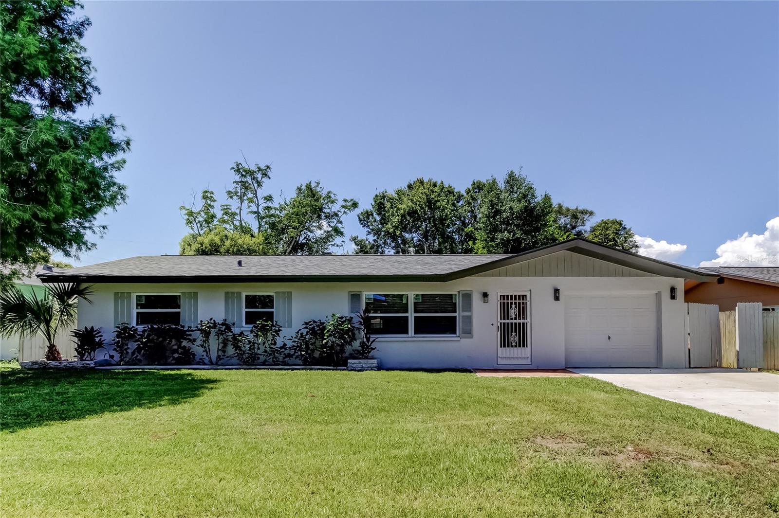 Beautifully renovated 3 Bedroom, 2 Bathroom, 1 Car Garage block home in a quiet, centrally located Clearwater neighborhood! The layout features a split bedroom plan and family room/living room/kitchen combo with a fireplace. NEW waterproof wood plank vinyl flooring throughout the home. An amazing newly remodeled kitchen boasts NEW shaker cabinets, gorgeous granite countertops, recessed lighting and stainless steel appliances. Beautiful, newly remodeled modern bathrooms as well. French doors lead to a screened-in porch and completely fenced backyard. For peace of mind, updates include a new roof (2023), new vinyl double pane hurricane windows (2023), new HVAC System (2023), new water heater (2023), new garage door (2023). NO HOA FEES AND NO FLOOD INSURANCE REQUIRED. Live the Florida Lifestyle to the fullest with a short drive to Clearwater Beach, Safety Harbor, Downtown Dunedin, The Landings Golf Course, Crest Lake Park, The Sound Music Venue at Coachman Park, and more! Don't miss your opportunity to own this move-in ready Clearwater home!