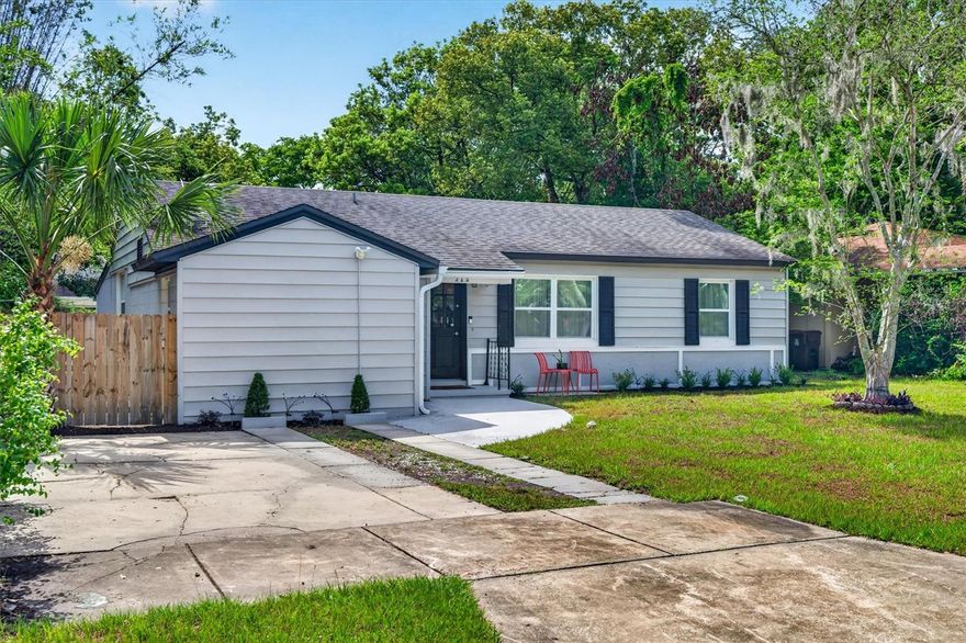 Welcome to 212 S Glenwood Avenue, a stylishly updated bungalow in the heart of Orlando's Historic Lake Lawsona neighborhood, walkable to the vibrant Milk District, Lake Eola Park, and Downtown Orlando, and with quick access to the 408 and I-4 just minutes away, making a commute anywhere across Central Florida effortless. Originally built in the 1950s and expanded over the years, this 4-bedroom, 2-bath home blends mid-century character with modern function. Fresh front-yard landscaping and a welcoming front entry lead into the original living room, with a nod to the mid-century modern vibe that sets the tone for the rest of the home. The flexible layout offers two bedrooms and a beautifully renovated bathroom on one side, while the other features two more bedrooms, one overlooking the oversized backyard through a large window that floods the space with natural light, and the other currently serving as an office. A charming dinette nook, currently styled as a bar, offers a fun breezeway into the main living/kitchen combo space. The updated kitchen, featuring all-new appliances, stone counters, and bar seating, opens into the main living area and out through sliding glass doors to a large covered lanai, making indoor-outdoor living and entertaining a breeze. Whether it's morning coffee outside or late-night hangs with friends, this home was designed for enjoying Orlando living year-round. The fully fenced backyard offers endless potential, room for a pool, garden beds, a firepit lounge, or your dream outdoor retreat. A true standout is the converted garage: a private, en-suite flex space with its own entrance, currently used as a crafts studio. Whether you need a guest suite, home office, home gym, creative workspace, or future income-producing apartment, this is square footage that works as hard as you do, a versatility few homes in the area would offer. A wide double-car driveway provides ample off-street parking out front, and street parking is widely available in front of the house. The home has been fully updated with new windows, updated electrical (2022), HVAC (2021), roof (2017), main sewer line replacement (2022), indoor laundry, and large-format tile plank flooring throughout for a seamless, clean, modern feel. With all the major systems already addressed, there's little left to do but move in and enjoy. Just a short bike ride to Mills 50 and steps from the Lake Eola Farmers Market and neighborhood parks, this home delivers the perfect mix of historic charm, creative energy, city convenience, and an unbeatable commute, all in one of Orlando's most walkable neighborhoods.