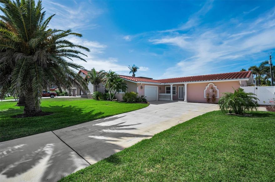 Experience the pinnacle of Belleair Beach living in this beautifully updated 3-bedroom, 2-bath residence, featuring a sparkling heated resort-style pool and an oversized garage, all just two blocks from the sugar-white sands and turquoise waters of the Gulf of Mexico. Nestled in one of the area's most desirable beach communities, residents enjoy exclusive deeded private beach access and a community boat ramp, providing effortless access to the Intracoastal Waterway and endless days on the water. Whether you're boating, fishing, paddleboarding, or simply enjoying spectacular sunsets, this exceptional location places you minutes from world-famous beaches, waterfront dining, boutique shopping, and a wealth of recreational opportunities, delivering the ultimate Florida coastal lifestyle.

Designed with entertaining in mind, this home offers multiple gathering spaces that flow seamlessly together. The spacious living and dining rooms serve as the heart of the home and are complemented by a stylish dry bar with additional seating, creating the perfect setting for hosting friends and family. Just beyond, the inviting family room and kitchen combination features an electric fireplace with custom built-ins and opens effortlessly to the outdoor living areas.

Completely remodeled in 2025, the stunning kitchen showcases white Shaker-style cabinetry, high-end Corian countertops, stainless steel appliances, and an induction cooktop. Whether you're hosting holiday celebrations, game-day parties, or casual family gatherings, the open-concept design allows guests to move comfortably between the living spaces while enjoying views of the backyard oasis.

Large windows and sliding doors overlook a sparkling heated swimming pool designed for year-round enjoyment. The resort-style pool features an expansive sun shelf, waterfall feature and built-in stools, creating a true tropical retreat right in your own backyard. The fully fenced yard offers privacy and plenty of space for outdoor entertaining.

The split-bedroom floor plan provides privacy for the primary suite, featuring new luxury vinyl plank flooring, a walk-in closet, and an ensuite bathroom with a jetted tub and separate shower. A spacious sunroom with a portable air conditioning unit offers flexible living space ideal for a home office, fitness room, hobby area, or additional entertaining space.

Additional improvements include:
• Remodeled Kitchen (2025)
• New Stainless Steel Appliances (2025)
• Water Heater (2025)
• Pool Pump (2025)
• Washer (2025)
• Dryer (2025)
• Concrete Tile Roof (2016)
• Fresh Interior Paint (2025)
• New Interior Doors (2025)

Live the ultimate Florida lifestyle with easy access to boating, fishing, paddleboarding, waterfront dining, and the Gulf Coast's legendary sunsets along Belleair Beach's pristine white sand shoreline. This exceptional home combines modern updates, resort-style amenities, and an unbeatable coastal location.