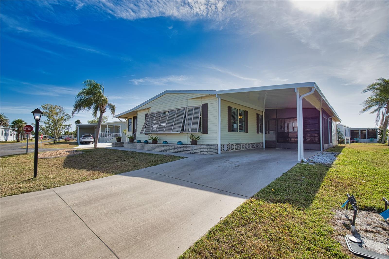 Discover the quintessential Florida lifestyle in this stunning home nestled on a spacious corner lot! The moment you step inside, you'll be captivated by the seamless flow of the open-concept design, where the kitchen, dining room, and living room come together to create the perfect backdrop for unforgettable gatherings with friends and family. The oversized kitchen is a chef’s dream, complete with an abundance of cabinet space and a large island that invites culinary creativity and conversation. For those cozy evenings, the generous Florida Room offers an inviting space to entertain or unwind with a good book and a refreshing drink. Retreat to the luxurious primary bedroom, where you’ll find an updated ensuite bathroom featuring a modern walk-in shower—your personal sanctuary. Your guests will feel truly at home in the spacious secondary bedroom, conveniently located just across the hall from another well-appointed bathroom. This exceptional property offers the perfect canvas for you to infuse your personal touch and create your dream home! Recent enhancements include a brand-new carport (2025), a stylish new shingle roof (2023), and stunning new vinyl siding (2023). Don’t miss the chance to make this remarkable home yours!
Welcome to La Casa, an enchanting community where 974 exquisite homes are beautifully set among native trees, surrounded by spacious common areas and eight serene lakes. Our generous 60 by 80-foot lots offer your ideal space. Perfectly located between Sarasota and Fort Myers, La Casa is a boater's paradise with direct access to the stunning Gulf of Mexico. Enjoy easy access to shopping, sightseeing, golfing, and fishing, all while immersing yourself in the rich culture of Southwest Florida. Experience the warmth of Southwest Florida’s winters in a relaxed environment, far from the east coast hustle. Our lush, mature landscaping reflects the dedicated care of residents and management. La Casa features some of the finest pools in the area, including our magnificent 40 by 60-foot swimming pool, maintained at a delightful 87 degrees, and a cozy 20 by 40-foot pool nestled between the clubhouse and Activity Building, both with inviting hot tubs. Stay connected with our complimentary Wi-Fi at the Clubhouse, Activity Building, and Recreation Hall while you soak up the sun. La Casa is a family-friendly haven where you can enjoy tranquility while remaining close to vibrant attractions. Come visit our charming oasis and discover why La Casa is the ultimate destination for snowbirds and year-round residents!