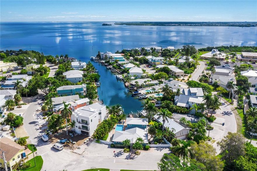 Welcome to Paradise at Harbor Side, a wonderful 5 Bedroom, 3.5 Bathroom waterfront property located in a prime location in Holmes Beach.  Step outside your front door and head directly to the sparkling water of the Gulf of Mexico beaches or step outside the back door and hop on your boat, jet ski, kayak, or paddleboard and take off on the crystal blue waters!  This spacious home has nearly 3,000 square feet of living space to accommodate all of your family and friends comfortably.  The open concept floorplan is replete with natural light and spectacular water views. The kitchen is beautifully equipped with stainless steel appliances, granite countertops, and countertop bar to enjoy your meals and company.  The living and dining area has a generous amount of space for comfortable living.  All bedrooms are arranged for privacy.  The master bedroom king suite, which includes a soaking tub and walk-in shower, is on the ground floor, along with a large guest room and bunk room.  There are two more bedroom upstairs on the second floor with amazing views.  When it is time to relax, head out to the tropical pool or grill and chill in the lounge and outdoor dining area.  This wonderful home also has an expansive 50 feet of water frontage and a dock with electric and 10,000-pound boat lift.  Hop on your boat and cruise directly in and out of this naturally wide canal to the Bay and amazing Gulf waters. You also can fish from your dock or just sit and watch the manatees and dolphins play!  This is a spectacular island home and lucrative rental investment. *Bonus weekly rental at this location!  This beautiful home also has a trolley stop right out the front door, and world class shopping and restaurants are located just minutes away.  Call today for a private tour.