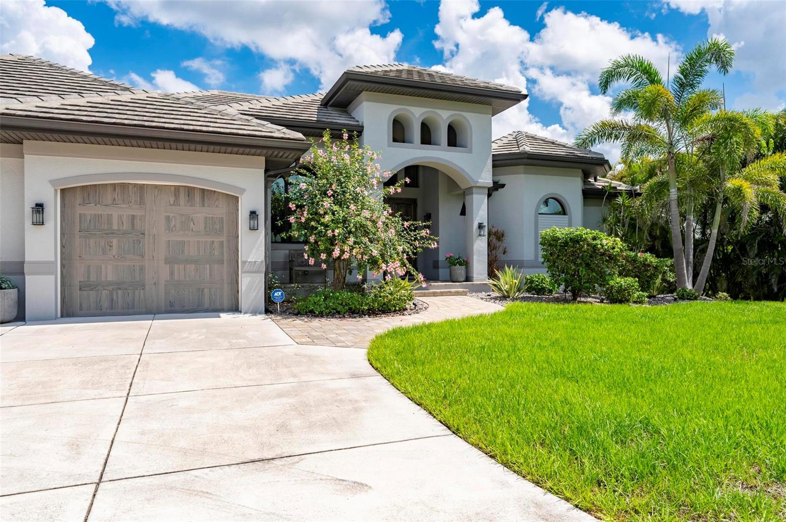 Stunning custom designed, gulf access pool home with unobstructed waterfront views of Charlotte Harbor on a large 1 acre lot. This gorgeous 2019 built home boast 3 bedrooms + den, 3.5 baths and an oversized 3 car garage. As you arrive, the winding concrete circular driveway welcomes you to a raised entry with custom 10ft doors. Step inside and your eyes will be immediately drawn to the expansive water view of Charlotte Harbor. Interior features include 14ft coffered ceiling in the great room with full pocket sliders to the huge 35x15 covered lanai with outdoor kitchen, outdoor shower, infinity edge pool and attached hot tub placed perfectly to view the open water. The kitchen offers high quality cabinets with quartz counter tops, center island, cook top, oven and microwave. The Primary Bedroom boasts open water views, double walk in closets and a dream 19x15 en suite with double vanities and roman style shower. Guest bedroom 2 also has open water views and an en suite that doubles as the pool bath. The large indoor laundry room has attached 16x11 bonus/craft room. The large 33ft wide and 23ft deep 3 car garage provides ample space for large SUV's or workshop. For boating access to Charlotte Harbor and the Gulf there is a deeded 600ft dock extending out into the Peace River.