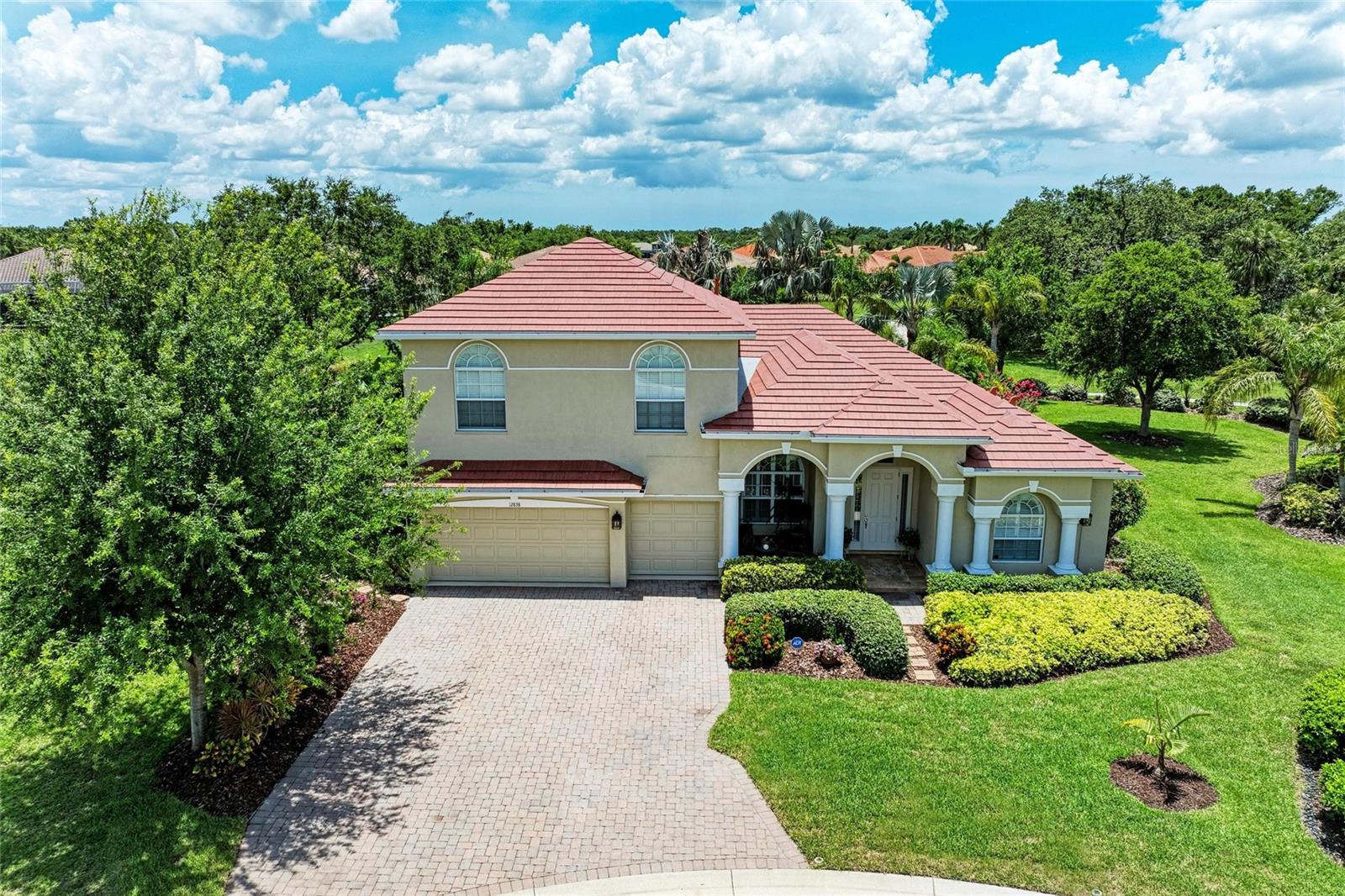 Stunning Pool Home with BRAND NEW ROOF on a Rare ½ acre lot in the Gated Community of Greyhawk Landing! This beautifully maintained residence offers a rare combination of space, privacy, and serene Florida living. Situated on a sprawling, lushly landscaped homesite with fruit, palm, and oak trees. The property offers peaceful preserve views, creating a private backyard oasis complete with screened-in pool & spa, open air paver patio, and plenty of room for outdoor entertaining and a play area for the little ones and pets. Inside, you’ll find over 3,850 sq ft of thoughtfully designed living space featuring 4 bedrooms, 3.5 bathrooms, a private office/den, an upstairs bonus room, and a 3-car garage. Natural light floods the home, highlighting high ceilings and fresh, modern finishes throughout. The renovated kitchen is a chef’s dream, showcasing newly painted linen cabinetry, quartz countertops, a stylish tile backsplash, and all-new stainless-steel appliances, including a 4-burner gas cooktop, built-in oven, microwave, and refrigerator. The cozy breakfast nook with aquarium glass windows and updated lighting offers the perfect spot to enjoy morning coffee while taking in pool and preserve views. The spacious family room flows effortlessly from the kitchen, creating an ideal space for gatherings. On the main level, the owner’s suite offers a peaceful retreat with views of the pool, an oversized walk-in closet, soaking tub, dual vanities, and a glass-enclosed shower. Three additional bedrooms are situated on the opposite side of the home, along with two full bathrooms for added convenience. Upstairs, a massive bonus room and half bath provide flexible space for a game room, media room, or guest retreat. The 3-car garage boasts a fresh epoxy painted floor, workbench and built-in storage. Additional upgrades include IMPACT GLASS WINDOWS on front and second floor windows, luxury vinyl plank flooring in all bedrooms, engineered hardwood in living room, freshly painted interior and exterior, new dining fixtures and ceiling fans, Italian Mosaic Tile entry, and immaculate pride of ownership throughout. ONLY $75 A YEAR HOA DUES! Greyhawk Landing is a vibrant, 24-hour gated community known for its resort-style amenities, including two club houses, two community pools--one lagoon-style with water slides and waterfall—playgrounds, a fitness center, basketball, baseball and soccer fields, tennis courts, pickleball, basketball court, nature trails, and more. Ideally located near top rated schools, Lakewood Ranch, shopping, dining, and the beautiful Gulf Coast beaches—this home truly offers the best in Florida Living!