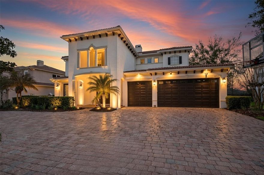 This stunning waterfront model home in the prestigious gated community of Bronson's Landing in Winter Garden, Florida, offers the perfect blend of luxury, comfort, and waterfront living.  Step inside to an elegant foyer featuring a custom staircase and a private office, setting the tone for this thoughtfully designed 5-bedroom, 5-full-bath residence with an additional loft, theater room, and versatile flex spaces ideal for relaxation and effortless entertaining.  The heart of the home is the expansive open-concept gourmet kitchen, boasting sleek stone countertops, modern hardware, premium stainless steel appliances, built-in ovens, abundant cabinetry, a walk-in pantry, and a large island bar overlooking the sparkling pool, extended lanai, and tranquil pond views. Upgraded wood flooring flows throughout, while abundant natural light floods the seamless kitchen, dining, and living areas creating an inviting space perfect for year-round gatherings.  The luxurious primary suite is a true retreat, with peaceful water views, crown molding, and a spa-like en-suite bath featuring a large soaking tub, separate shower, and an extended walk-in closet with custom built-ins. Upstairs, a second master bedroom awaits, complete with its own private sitting area and full bath that’s ideal for multigenerational living or guests seeking privacy.  Generously sized secondary bedrooms accommodate family or visitors comfortably, while the flexible upstairs theater/flex room with kitchenette doubles as a superb loft or secondary living space.  Outside, your private outdoor oasis beckons: an extended covered lanai with sliding glass doors opens to a resort-style pool and spa, fully fenced extended backyard, and panoramic water views that make every day feel like a vacation.
Additional premium features include custom window treatments, designer lighting throughout, a whole-home central vacuum system, energy-efficient double-pane windows, and a convenient 3-car attached garage.  Immaculately maintained and brimming with thoughtful details, this exceptional waterfront home must be experienced in person to truly appreciate its elegance and tranquility.