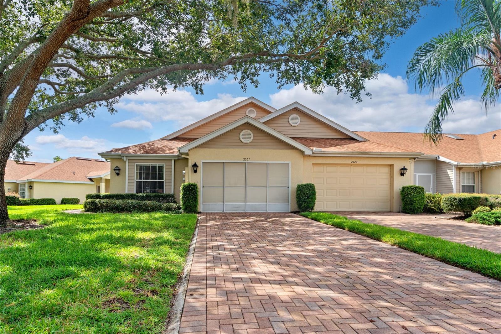 Welcome to this picturesque villa-style condo in the sought-after 55+ Nantucket community of Kings Point. From the moment you arrive, the charm is undeniable—mature trees and a shaded pavered driveway frame this end-unit villa, offering both privacy and curb appeal. With 2 bedrooms, 2 bathrooms, and a 1-car garage, this well-maintained home provides 1,250 sq. ft. of comfortable living space plus the garage and screened in porch.
Step inside to find soaring ceilings and an open floor plan that enhances the sense of space and light. The split layout features a primary suite with a walk-in closet and private en-suite bathroom, while the guest bedroom and bath ensure comfort for visitors. At the heart of the home, a screened lanai invites you to relax and soak in tranquil pond views—a perfect backdrop for morning coffee or evening unwinding. Enjoy one of the rare homes for sale with water views out the master bedroom!
Enjoy peace of mind with comprehensive monthly fees that cover cable, internet, exterior insurance, lawn care, pest control, security, water, trash, sewer, and even roof repair/replacement. Beyond your doorstep, Kings Point offers a resort-style lifestyle with two clubhouses, indoor/outdoor pools, two fitness centers, an on-site spa, golf, pickleball, shuffleboard, and over 150 clubs and activities to keep every day engaging.
Conveniently located near shopping, medical facilities, and major roadways including US-301, US-41, and I-75, this villa puts you close to everything while keeping you nestled in the comfort of a vibrant, gated community.
Experience the best of Florida’s active adult living—right here in Kings Point.