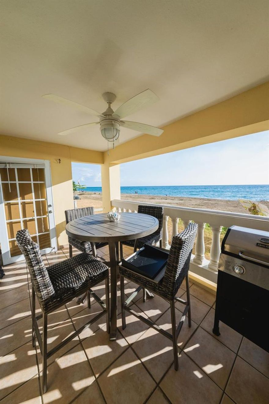 Wake up to the sound of the waves and enjoy true beachfront living in this bright and comfortable oceanfront apartment in beautiful Rincón. Perfect for couples, small families, digital nomads, or surfers looking for a relaxing coastal stay with everything you need. This fully furnished apartment offers a warm, open layout with plenty of natural light and direct ocean views. Enjoy your morning coffee and evening sunsets just outside your door. Features; Direct oceanfront location, private balcony/patio with seating and sea views, comfortable living room with sofa and TV, fully equipped kitchen with stove, oven, microwave, dishwasher & coffee maker, dining area with ocean-view windows, In-unit washer & dryer, high-speed WiFi, air conditioning, bright and breezy interior with tile floors throughout. Located in Rincón, known for its world-class surfing, sunsets, and laid-back beach-town vibe. Close to beaches, restaurants, cafes, and local attractions yet peaceful enough to unwind and recharge. Enjoy ocean breezes, golden sunsets, and the best of Rincón right outside your door.