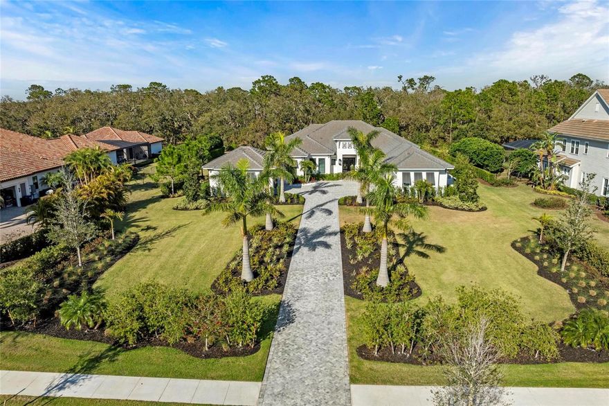 Luxury Living in The Concession – Custom John Cannon Estate. 

Experience unparalleled luxury in this exquisite 5-bedroom, 4-bathroom estate in the exclusive Concession Golf Club & Residences. Built by the renowned John Cannon Homes, this masterpiece offers a seamless blend of elegance, comfort, and state-of-the-art amenities with attention to detail in every corner.

Upon arrival you will be embraced by a pristine elongated and landscaped driveway. Walking up greeted by 12 food iron double doors. Stepping inside to soaring ceilings, crown moldings, custom designer finishes, and an open-concept layout perfect for both entertaining and everyday living. The chef’s kitchen boasts top-of-the-line kitchen aid cafe series appliances, custom zero face cabinetry, double dishwasher, ice maker, elegant backsplash, and a spacious island...flowing effortlessly into the great room with expansive glass doors that open to a breathtaking outdoor oasis. The picture window behind the island and counter provide natural light for enjoying testing out that new recipe. Cathedral ceilings with wood beams create a breathtaking flow to character and outdoor entertaining.

The primary suite is a retreat of its own, featuring a spa-like en-suite bath, oversized walk-in closets, and private access to the lanai. The additional 4 bedrooms offer ample space and privacy, ideal for family and guests. Two bedrooms with the separate en-suite bathroom and 2 bedrooms with a jack-n-jill bath. 

The additional lifestyle rooms like den/office off the primary suite perfect for the work from home opportunity. The bonus room in the back of the home offers a great space for gatherings, playroom, or additional hobby area. The expansive laundry room across from walk in pantry displays ample custom cabinetry for storage, additional refrigerator, and DOUBLE washer and dryer.

Car enthusiasts will love the 5-car garage, which includes a custom climate-controlled workout bay, perfect for fitness enthusiasts or additional storage or hobbies.

Outside, the resort-style saltwater pool and spa are surrounded by a lush, private landscape, complemented by an outdoor kitchen and covered lanai, making this home perfect for embracing the Florida lifestyle. This home is boasting endless upgrades including a full technology space which includes a whole home Sonos Sound System.

Located within one of Florida’s most prestigious gated communities, The Concession offers world-class golf, fine dining, and unparalleled tranquility, all while being just minutes from Sarasota’s white-sand beaches, shopping, and entertainment.

Don't miss the opportunity to own this one-of-a-kind estate- upgrades are endless, schedule your showing for a full list!