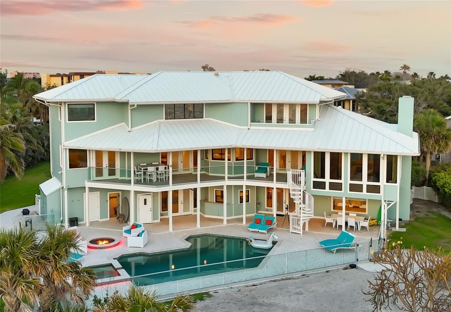 Exclusive Gulf Coast Luxury Beachfront Estate with Private Gulf Access and Endless Ocean Views
Welcome to one of the Gulf Coast’s most private and luxurious beachfront estates—an extraordinary opportunity to
own a rare stretch of direct Gulf frontage in Florida. Tucked away at the end of a quiet cul-de-sac and secured behind
dual gated entrances, this expansive oceanfront property is enveloped in lush tropical landscaping and designed for
those who value seclusion, sophistication, and long-term legacy.
Boasting 233 feet of pristine beachfront along the Gulf of Mexico, this remarkable estate spans over 8,000 square feet
under air and has been completely reimagined through a meticulous, high-end renovation. It artfully blends timeless
elegance with resort-style comfort, offering panoramic water views from nearly every room. Here, no neighbors
interrupt the horizon—only serene coastal breezes and iconic Florida sunsets that feel like they belong to you alone.
Designed for multi-generational living or grand-scale entertaining, this coastal residence features five private bedroom
suites—including a separate in-law or nanny suite—as well as a dedicated home office that can serve as a sixth
bedroom. Two full gourmet kitchens, five expansive balconies, and an elevator servicing all three levels ensure

exceptional comfort and convenience throughout. The main living areas showcase open-concept design, natural light,
and breathtaking vistas that define luxury Gulf Coast living.
Resort-level amenities abound, including a heated, saltwater pool that reaches 10 feet deep, a hot tub with massage
jets, a full steam room, and an infrared sauna for ultimate relaxation. A whole-home Sonos audio system, a 12-camera
security network, and a powerful 60 kW natural gas generator provide modern convenience and peace of mind. Water
quality is managed by an advanced reverse osmosis filtration system and whole-house conditioner, while a 70-foot
private well supplies multi-zone irrigation for the manicured grounds.
The property also features a unique drive-through two-car garage with an air-conditioned storage loft, three HVAC zones
plus a mini-split system, LED color-changing lighting throughout, and outdoor enhancements such as a built-in gas grill, a
fire pit, and an illuminated waterfall feature—ideal for entertaining under the stars.
An adjacent buildable lot expands your opportunity for growth, allowing space for a future guest house, expanded
estate grounds, or added privacy. This is more than a home—it's a one-of-a-kind legacy property offering privacy, luxury,
and an irreplaceable position along Florida’s Gulf Coast.
Now available exclusively by private appointment, this luxury beachfront retreat is the ultimate in coastal real estate.
Don’t miss your chance to own a slice of Gulf-front paradise.