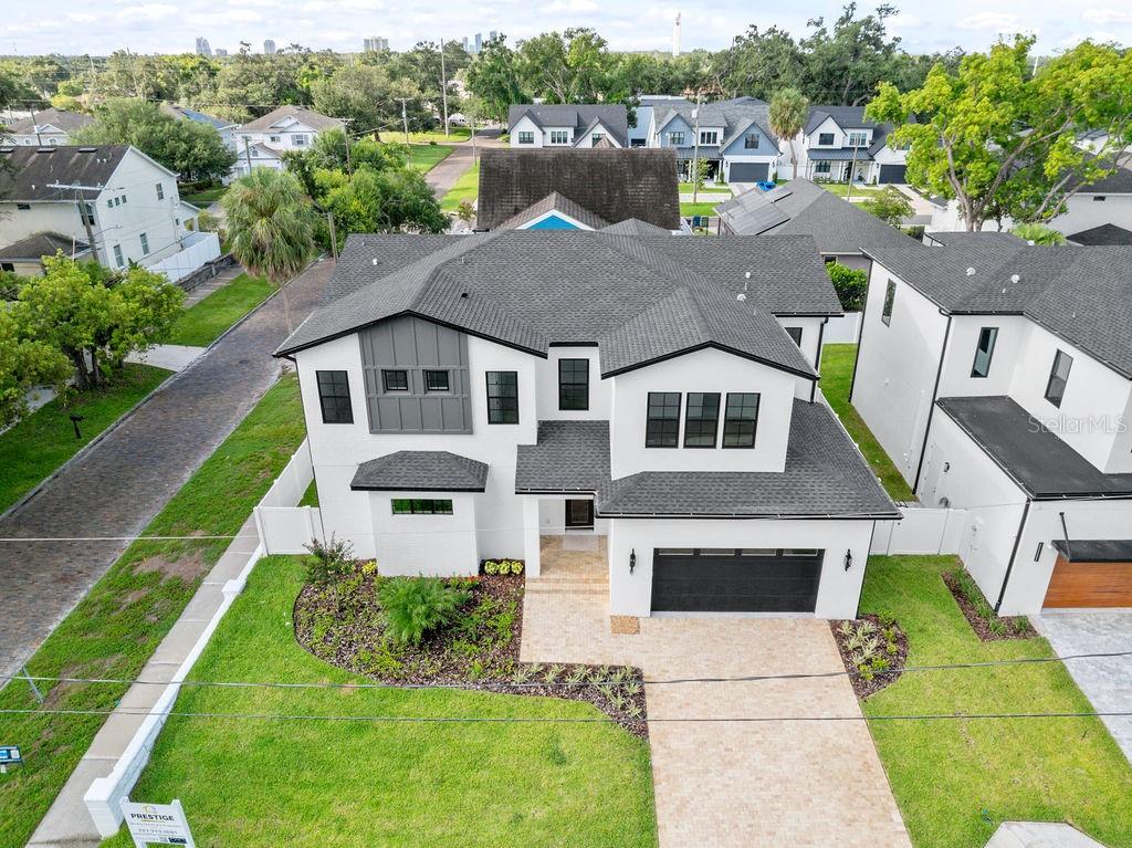 Contemporary Luxury on a Premier Corner Lot in the Heart of Midtown – 3202 W La Salle Street
Welcome to 3202 W La Salle, a custom-built modern masterpiece situated on a **highly desirable corner lot** in one of South Tampa’s most coveted neighborhoods—just steps from Midtown and minutes from Downtown. This rare corner position offers enhanced privacy, expanded yard space, abundant natural light, and superior curb appeal from multiple vantage points—setting this home apart in both presence and potential.
Thoughtfully designed with clean lines and elevated finishes, this residence delivers 3,781 sq. ft. of heated living space (4,302 sq. ft. under roof), including **5 bedrooms, 4 full baths, 2 half baths**, and an oversized 2-car garage. The property also features a **rear-accessible alleyway**, providing convenient access for upgrades, additional parking, or future pool installation with ease.
Step inside to soaring 20-foot ceilings and a dramatic second-story overlook that instantly commands attention. The expansive open-concept layout creates a light-filled atmosphere, perfect for entertaining or relaxing in style. At the heart of the home, the chef’s kitchen stuns with a quartz waterfall island, professional-grade range, and seamless integration to the living and dining spaces. A glass-enclosed wine room with built-in wine fridge adds a touch of refinement, showcasing your collection with elegance.
The **first-floor primary suite** is a true retreat, offering his-and-hers oversized walk-in closets, a spa-inspired bathroom with dual vanities, an expansive walk-in shower, and the convenience of a private laundry area.
**Upstairs, you’ll find four additional bedrooms**, including a secondary suite with a large walk-in closet and ensuite bath—perfect for guests, teens, or multi-generational living. A spacious loft anchors the upper level and leads to the remaining bedrooms, each generously sized and thoughtfully appointed. An upstairs laundry room adds ease to daily life.
Outside, the fully fenced backyard oasis offers exceptional outdoor living potential, enhanced by the corner lot's **wider side setbacks** and **multiple access points**. Enjoy a covered patio perfect for al fresco dining, lounging, or expanding your outdoor living space even further.
This home was built with no compromises—impact-rated windows, 8-foot solid-core doors, Level 4 drywall, spray foam insulation, and engineered hardwood flooring throughout. It’s fully pre-wired with Cat 6, indoor/outdoor speaker wiring, and cameras—all centralized through a dedicated data closet for seamless smart home integration.
**Unbeatable location on a rare corner lot**: walk to Midtown Tampa, and enjoy quick access to Armature Works, Water Street, Amalie Arena, Downtown, and Raymond James Stadium.
**Experience the ultimate blend of luxury, privacy, technology, and location—schedule your private showing today.