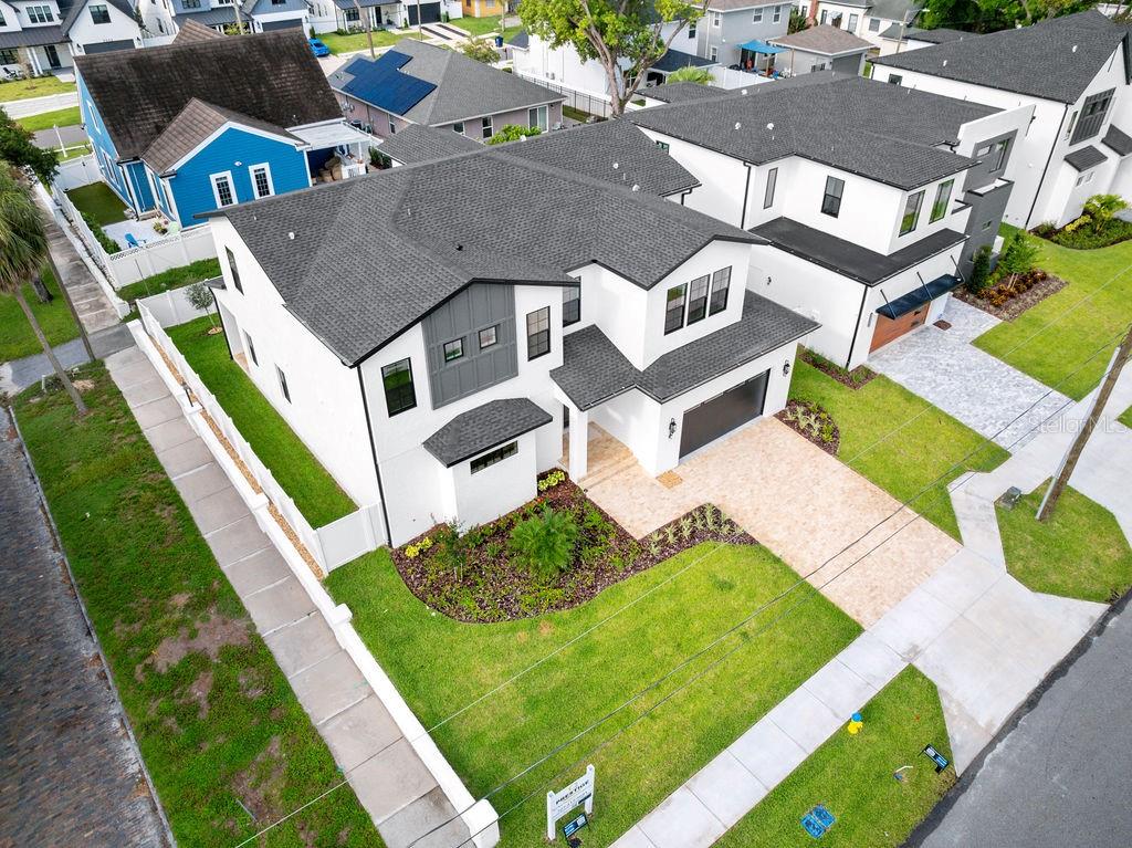 Contemporary Luxury on a Premier Corner Lot in the Heart of Midtown – 3202 W La Salle Street
Welcome to 3202 W La Salle, a custom-built modern masterpiece situated on a **highly desirable corner lot** in one of South Tampa’s most coveted neighborhoods—just steps from Midtown and minutes from Downtown. This rare corner position offers enhanced privacy, expanded yard space, abundant natural light, and superior curb appeal from multiple vantage points—setting this home apart in both presence and potential.
Thoughtfully designed with clean lines and elevated finishes, this residence delivers 3,781 sq. ft. of heated living space (4,302 sq. ft. under roof), including **5 bedrooms, 4 full baths, 2 half baths**, and an oversized 2-car garage. The property also features a **rear-accessible alleyway**, providing convenient access for upgrades, additional parking, or future pool installation with ease.
Step inside to soaring 20-foot ceilings and a dramatic second-story overlook that instantly commands attention. The expansive open-concept layout creates a light-filled atmosphere, perfect for entertaining or relaxing in style. At the heart of the home, the chef’s kitchen stuns with a quartz waterfall island, professional-grade range, and seamless integration to the living and dining spaces. A glass-enclosed wine room with built-in wine fridge adds a touch of refinement, showcasing your collection with elegance.
The **first-floor primary suite** is a true retreat, offering his-and-hers oversized walk-in closets, a spa-inspired bathroom with dual vanities, an expansive walk-in shower, and the convenience of a private laundry area.
**Upstairs, you’ll find four additional bedrooms**, including a secondary suite with a large walk-in closet and ensuite bath—perfect for guests, teens, or multi-generational living. A spacious loft anchors the upper level and leads to the remaining bedrooms, each generously sized and thoughtfully appointed. An upstairs laundry room adds ease to daily life.
Outside, the fully fenced backyard oasis offers exceptional outdoor living potential, enhanced by the corner lot's **wider side setbacks** and **multiple access points**. Enjoy a covered patio perfect for al fresco dining, lounging, or expanding your outdoor living space even further.
This home was built with no compromises—impact-rated windows, 8-foot solid-core doors, Level 4 drywall, spray foam insulation, and engineered hardwood flooring throughout. It’s fully pre-wired with Cat 6, indoor/outdoor speaker wiring, and cameras—all centralized through a dedicated data closet for seamless smart home integration.
**Unbeatable location on a rare corner lot**: walk to Midtown Tampa, and enjoy quick access to Armature Works, Water Street, Amalie Arena, Downtown, and Raymond James Stadium.
**Experience the ultimate blend of luxury, privacy, technology, and location—schedule your private showing today.