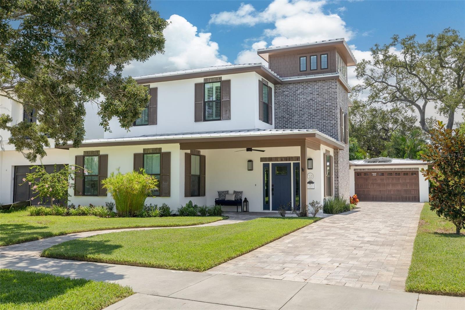 Tucked away on one of Clearwater’s most exclusive and historic streets in the coveted Harbor Oaks neighborhood, this newer construction masterpiece—built in 2022—combines Italianate-inspired architecture with modern sophistication. A timeless treasure, the residence features 5 bedrooms and 3.5 bathrooms, including a luxurious primary suite conveniently located on the first floor. Designed for both elegance and function, the open floor plan is enhanced by abundant natural light, exceptional storage, and refined finishes throughout. An upstairs loft offers additional living space, perfect for a home office, media room, or lounge. Every detail reflects quality and comfort—from hurricane-rated windows, Bosch appliances, and custom Closets by Design systems in every closet, to a 14x16 spa offering the ultimate in relaxation. Modern innovation elevates daily living with solar panels, a gas tankless water heater, and an electric vehicle charging station. Ideally located in a non-flood, non-evacuation zone, the home also offers peace of mind alongside its luxury features. Just steps away, residents enjoy the iconic Magnolia Fishing Dock, where evenings unfold with breathtaking sunsets over the Gulf. The home is also just a short distance from the reimagined Coachman Park, world-class entertainment at the Capitol Theatre and The Sound, and the vibrant shops and restaurants of Downtown Clearwater. Outdoor enthusiasts will appreciate nearby golf courses, the Pinellas Trail, Belleair Country Club, marinas, and of course, and the powder-soft sands of Clearwater Beach—just minutes away by foot or bike. Blending the timeless character of Harbor Oaks with today’s finest luxuries, this residence offers a rare opportunity waiting for you.
