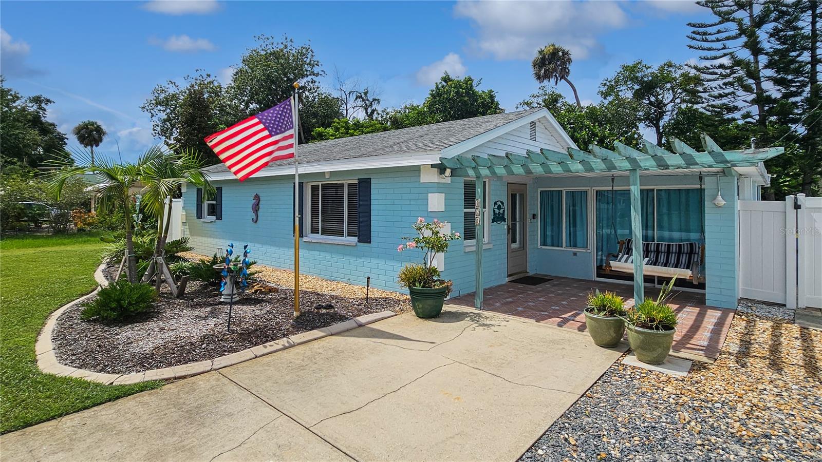 Charming 3-Bedroom home in a Tropical Paradise – Turnkey & Ready to Enjoy! This beautifully maintained 3BD, 1BA home offers the perfect blend of comfort, style, and convenience. The solid concrete block construction ensures durability, while the terrazzo floors add timeless character throughout the home. The kitchen features sleek stainless steel appliances (new in 2022), large basin sink, plenty of cabinets and even space for an island making meal prep a breeze. The home has been meticulously cared for, with updated electric, fixtures, and windows, ensuring a move-in-ready experience. And, it comes completely furnished and turnkey—just bring your suitcase! The tropical paradise backyard is lush with landscaping and even has a mature avocado tree offering both beauty and privacy. Avoid using the city water for irrigation! This home has a well and irrigation system. Enjoy the Florida lifestyle with front and rear porches, a spacious patio for outdoor gatherings, and plenty of room for relaxation. The backyard is fully fenced, providing the perfect retreat. Located between U.S.1 and Riverside Drive, you’ll have easy access to Downtown New Smyrna Beach (1.8-miles), Edgewater Public Boat Ramp (¾-mile) and the beach (3.75-miles). Bonus opportunity: There is a rental already booked for February, offering the potential for nearly $4,000 in income. This reservation can be kept or cancelled based on the buyer's preference.