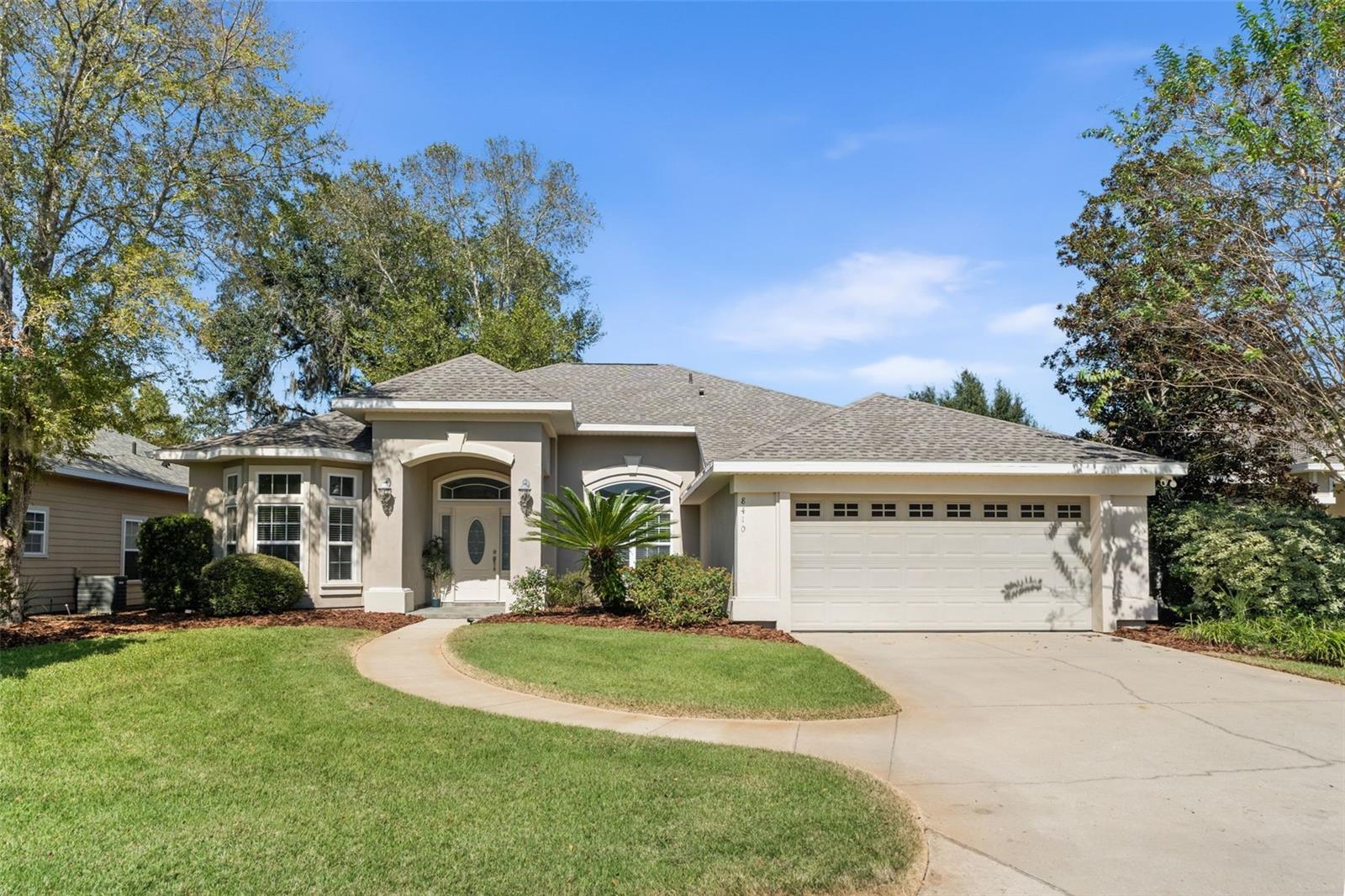 Beautifully maintained Cobblefield home in SW Gainesville! This residence offers 3 bedrooms, 2 bathrooms, and a dedicated office with double door entry and a bay window. Step inside this home into a bright and open floor plan with high ceilings, crown molding, tray ceilings and wood flooring through the main living space and office. You are greeted by the spacious living room with a cozy gas fireplace and built-in area. Adjacent is the light filled formal dining area. 
The kitchen features tall cabinets, crown molding, beveled edge laminate countertops, stainless steel appliances, vent hood, a breakfast bar and charming light filled breakfast area. From here, step out to the screened lanai and enjoy your morning coffee or outdoor dining. 
The spacious primary bedroom suite features two walk-in closets, an en-suite bathroom with dual vanities, a walk-in shower, jetted tub, and private access via French doors to the lanai.  
The laundry room leads to the two car garage and is equipped with a utility sink. The home also was reroofed in 2024.
Cobblefield residents enjoy sidewalks, green space, a community pool, and playground. Ideally located near UF/Shands, Celebration Pointe, Butler Plaza, and I-75, this home combines comfort, convenience, and timeless appeal. Don’t miss your chance to make this Cobblefield gem yours!