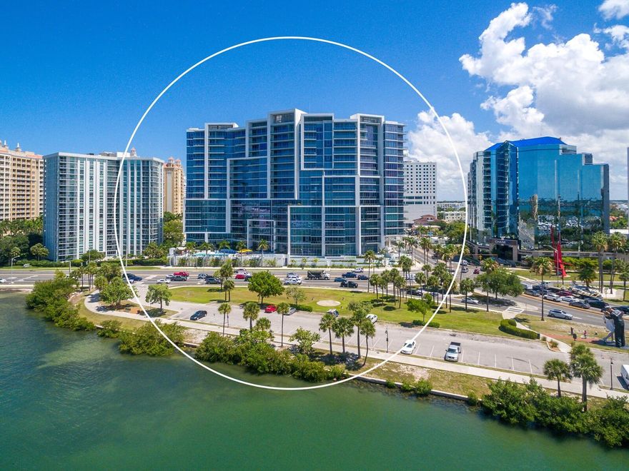 In one of the premier locations in the heart of Sarasota, VUE Sarasota Bay is poised at the gateway to Lido Key, St. Armands Circle and Longboat Key. This iconic 18-story condominium tower's striking architectural design was developed in concert with the adjacent Westin Sarasota. Available PENTHOUSE overlooking the Sarasota waterfront with 12' floor-to-ceiling glass walls, the tallest in The Vue to showcase unobstructed panoramic views of Sarasota Bay, Marina Jack, Ringling Bridge, Gulf of Mexico and downtown Sarasota! Enter your private foyer to reveal a gorgeous open kitchen and family room with the most beautiful turquoise backdrop inspired by the glistening water views of Sarasota Bay. The thoughtful planning and careful execution of this residence truly captures the essence of Sarasota. The kitchen features a built-in Sub-Zero refrigerator, premium stainless appliances, 36” gas JennAir cooktop, European Nolte cabinetry, custom tile backsplash, expansive quartz island and Italian porcelain tile. The built-in wine bar in the dining area adds a lovely touch for entertaining on your expansive 200-square-foot terrace with clear see-thru view railing. Dynamic modern touches are located throughout this versatile floor plan offering 3 en suite bedrooms and a den. Custom made motorized blinds and curtains add to the primary suite’s soothing and serene ambiance. The bath offers the ultimate in relaxation with a free-standing soaking tub, oversized glass shower, and large walk-in closet with ventilated wood shelving. Three covered parking spots right next to your semi-private elevator provide secure access directly to your front door. Luxury amenities include 24-hour concierge service, valet parking, club lounge, state-of-the-art fitness center, heated pool/spa with relaxation deck and fire table, and a roof-top dog park. Life at the VUE provides an urban, walkable lifestyle with convenient access to The Westin and Ritz Carlton amenities, downtown restaurants, Florida Studio Theater, the Sarasota Opera, many art galleries and bustling main street. A short distance to Selby Gardens and the new Bay Park Conservancy Park. When only the best views will do!