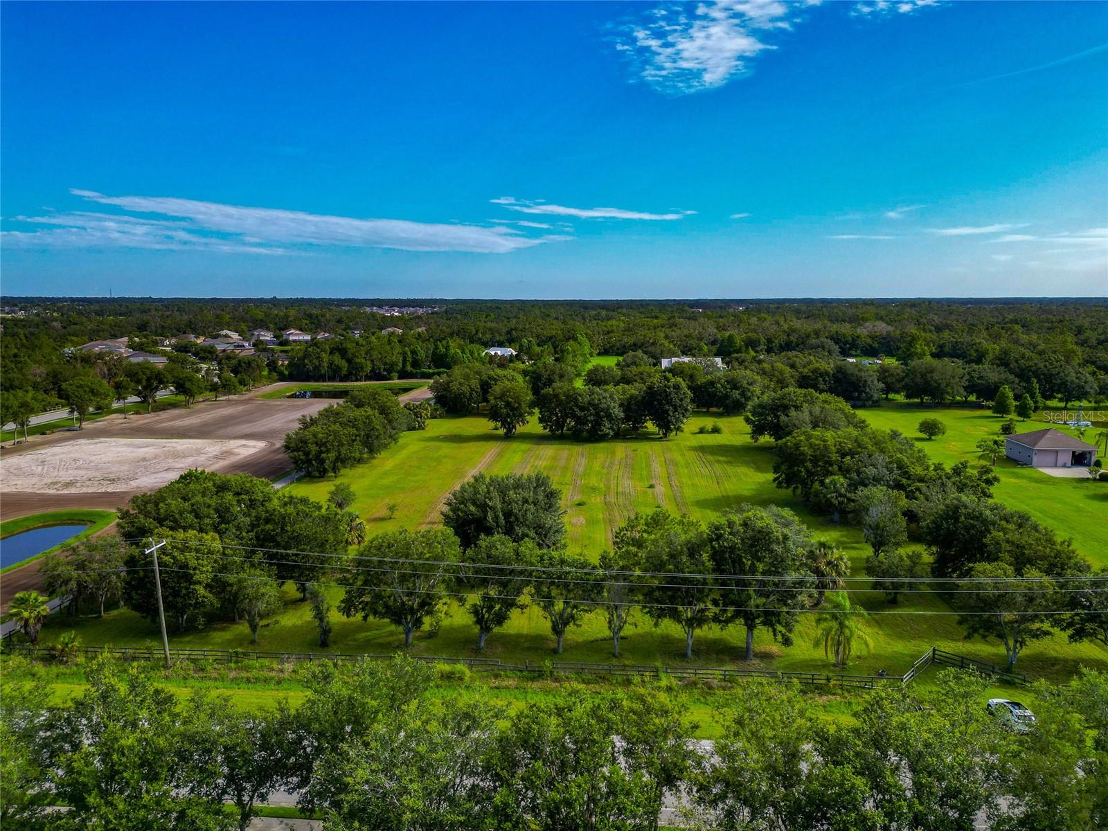 A rare 5-acre tract in one of Parrish’s most accessible rural corridors. This high-and-dry, cleared lot is fully fenced and zoned A (General Agriculture), giving you a wide range of options—build a custom home, bring in a modular or manufactured, add a barn, raise animals, or run an ag-based business. No deed restrictions, no HOA, and no CDD. Just land you can actually use.
The property has good topography, a mostly cleared footprint with some native trees, and plenty of room for outbuildings, gardens, and equipment. Located minutes from the Ft. Hamer Bridge, you’ll have quick access to Lakewood Ranch, I-75, Bradenton, and beyond. Schools, shopping, and new development are all close by—but the area still holds onto its rural character.
Whether you’re ready to build now or want to land bank for the future, this is a solid investment in a fast-growing part of northern Manatee County.