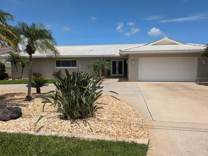 Great waterfront location in desirable Harbor Bluffs. Boater’s paradise with 4 beds 3 full baths and 2 car garage. Double door entry into the spacious living room where you are immediately greeted with a lovely waterfront view. Ideal floor plan. The large primary bedroom has a full en suite bathroom. The adjacent bedroom could  be used as a nursery, office, or den. Home features a split plan layout with additional 2 bedrooms and full bathroom. Large laundry room with sink has access to the 2 car garage. Oversized, solar heated, screen enclosed swimming pool has new equipment and color LED pool light. Primary suite, living room and dining room all have sliders providing direct access to the large paver deck which is perfect for entertaining. Watch the dolphins play and enjoy gorgeous sunsets! Property boasts 88 feet of protected intercoastal waterfront with new seawall and new dock installed in 2022. Deco Lift has recently been serviced and is ready for your boat!! Additional features include: Roll down hurricane shutters and irrigation system. Newer 4 ton air conditioner (2022). Newer water heater (2021) Circular driveway offers ample parking. Move in condition. Room dimensions are approximate and should be verified by buyer. Home warranty provided.