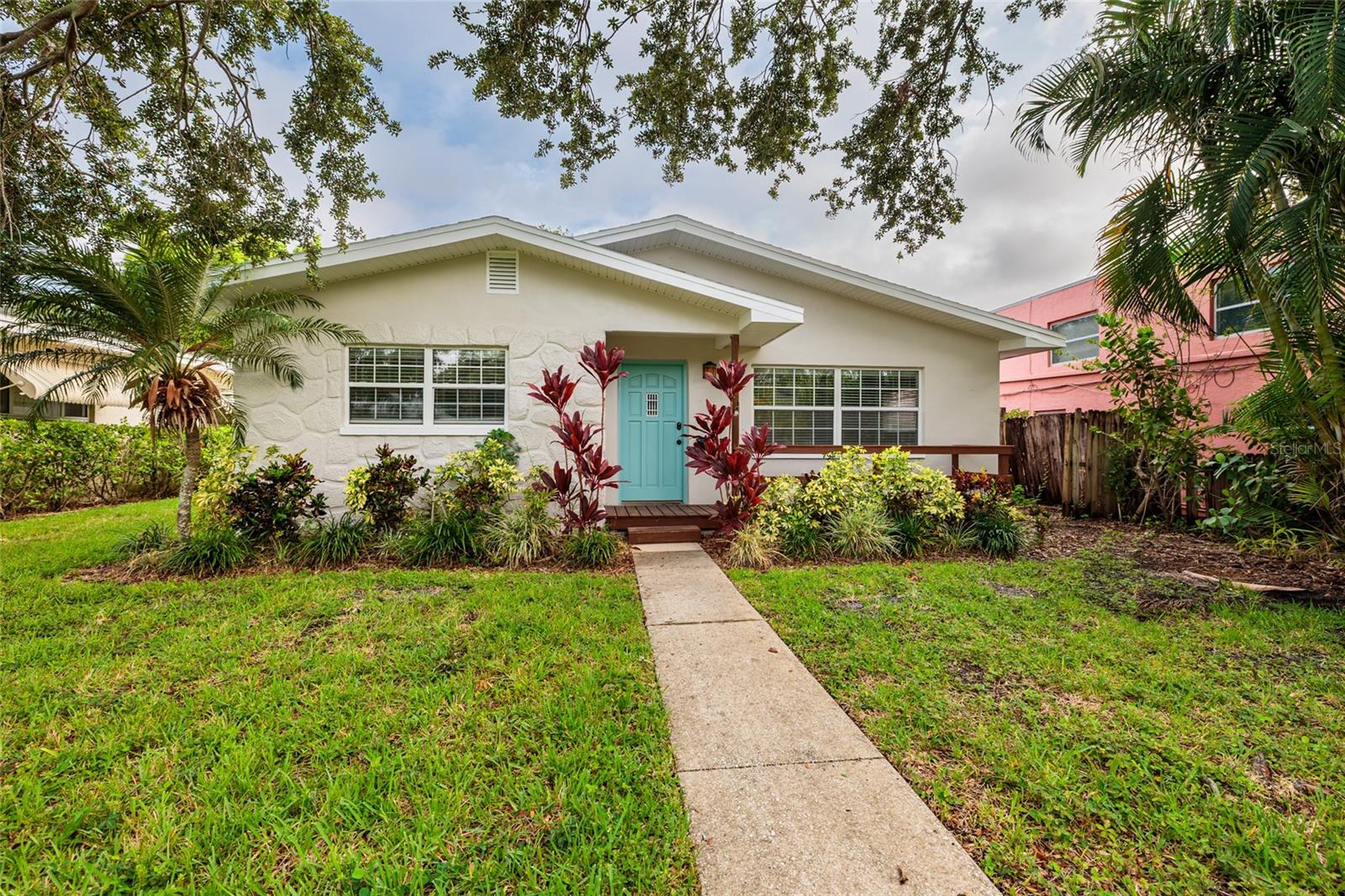 Charming single-family home nestled in the heart of St. Petersburg | This updated 2-bedroom, 2-bath residence offers an open layout with a bright living space that connects to the dining area. The spacious bedrooms provide comfort and flexibility, while the dedicated laundry room adds everyday convenience. Step outside to enjoy your private backyard oasis—complete with a covered deck, lush landscaping, and a fun tiki bar area perfect for entertaining. Additional features include a one-car garage and an expanded driveway for ample parking. Located just blocks from Coffee Pot Bayou, Vinoy Park, and vibrant downtown St. Pete, this home offers the perfect blend of historic charm, walkable living, and modern amenities. Don’t miss the opportunity to enjoy the lifestyle and community feel that make St Petersburg one of the most beloved city’s.