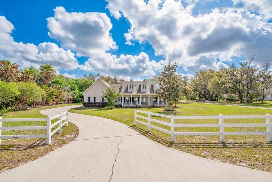 Country living at its finest! This stunning farmhouse-style estate on 1.5 acres near FishHawk offers the perfect blend of peace, privacy, and practicality—with NO HOA, NO CDD, and access to top-rated schools. Boasting nearly 3,262 sq ft with a 2 car attached Garage AND a 50 x 25 Detached Garage! The beautifully updated main home features 4 bedrooms, 2.5 baths, maple hardwood floors, plantation shutters, and a desirable split-plan layout with a luxurious primary suite, three additional main-floor bedrooms and a huge upstairs bonus room. The showstopper exterior includes grand oak trees, lush landscaping with irrigation and lighting, and a massive covered and screened lanai overlooking a private saltwater pool and spa—complete with a fully equipped “Mac Daddy” outdoor kitchen featuring a Green Egg, gas grill, side burners, and refrigerator. Need space? This property delivers with a 50x25 air-conditioned detached garage (34x25 enclosed with 2.5-ton mini split), a 50x40 open pole barn with full RV hookups (30 & 50 amp), epoxy garage floors in the main home garage, and no deed restrictions—bring your RV, boat, animals, or business equipment! Major updates include a 2022 roof with transferable Owens Corning Platinum warranty, HVAC systems (2018) with UV lights and whole-house air cleaner, new septic drain field, updated pool equipment (2025), and wired security systems in both the home and garage. Conveniently located just 30 minutes to Tampa or Lakeland and minutes to FishHawk, Plant City, and Brandon, this is a rare opportunity for small business owners, car collectors, or equestrian enthusiasts—schedule your private tour today!