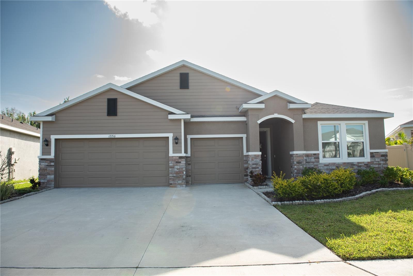 This one-story, all concrete block constructed home has a truly open concept plan, featuring a large great room, separate dining room, and well-appointed kitchen with dining area, all overlooking a covered lanai. This single story plan features two bedrooms at the front of the home which share a jack-and-jill full bathroom, as well as a multi-gen living space past the powder bath and laundry room. The owner's suite is located on the back of the home for privacy, offering beautiful views of the backyard. This community offers a well-rounded lifestyle with amenities like a modern clubhouse, fully equipped fitness center, fun-filled playground, and a sparkling pool—perfect for relaxation, recreation, and connecting with neighbors.