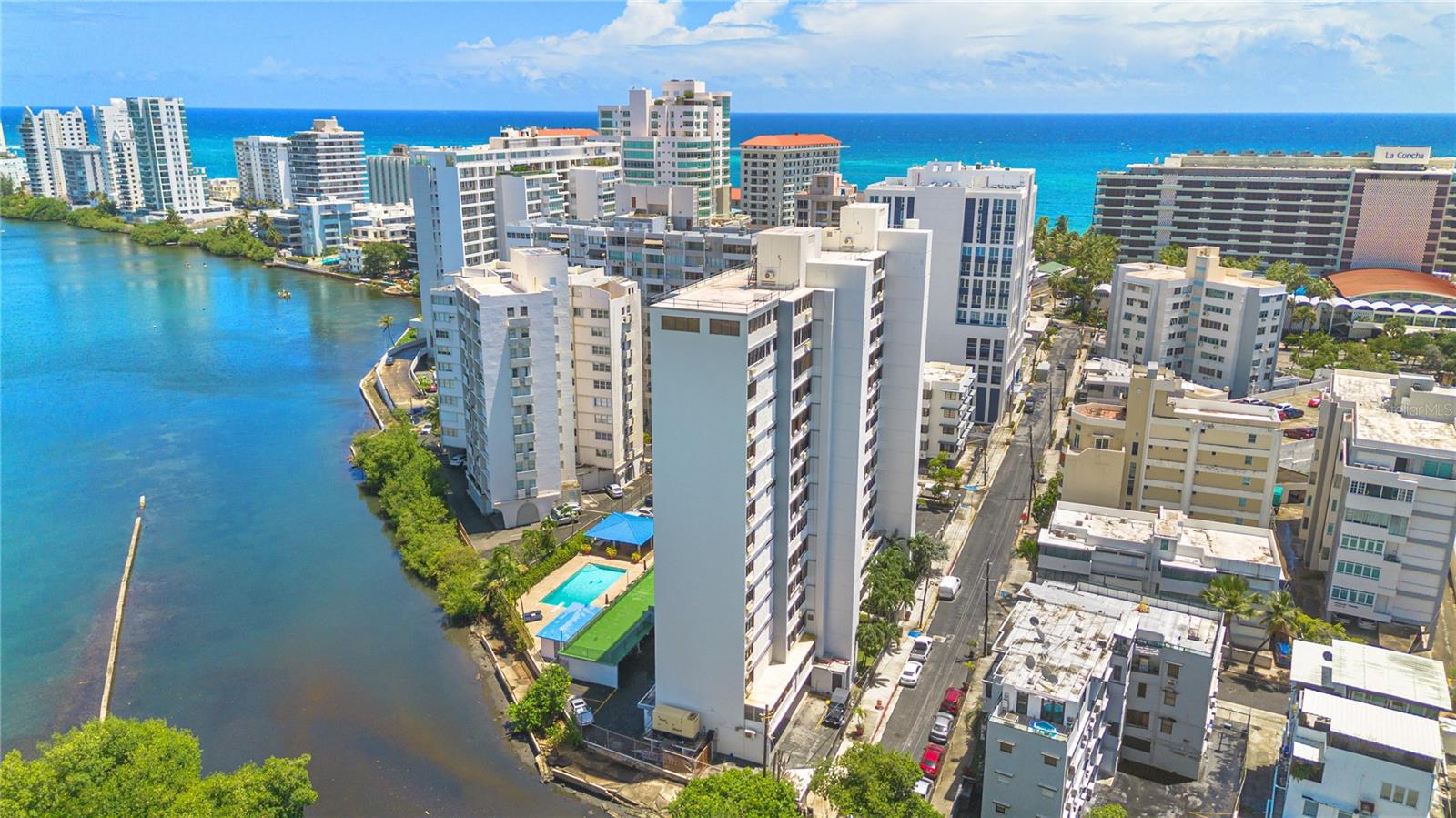 Experience lagoon-front living at its finest in this beautifully renovated apartment at Condominio del Mar, located at 20 Calle Delcasse in San Juan, Puerto Rico. This fully furnished residence offers two spacious bedrooms plus a den, ideal for a home office or guest space. Thoughtfully designed with a blend of comfort and style, the apartment features select high-end designer furniture pieces and premium appliances throughout. Enjoy modern finishes and the peace of mind provided by electric roller storm shutters, a building generator supporting common areas and the refrigerator, and an in-unit battery backup that powers the internet and essential lighting. Residents can also take advantage of the building’s amenities, including a serene lagoon-front pool and a gazebo perfect for relaxing or entertaining. This is a rare opportunity to live in a turnkey, high-quality home in one of San Juan’s most desirable Condado location, just steps from Ashford Ave and beach access.