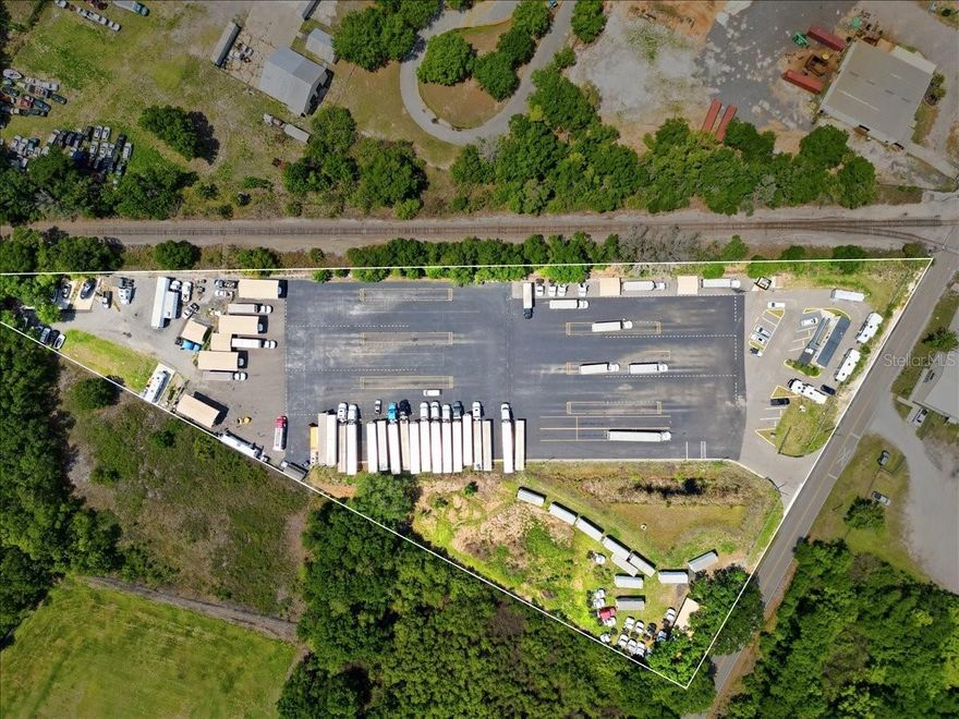 Fully DEVELOPED and OPERATIONAL INDUSTRIALLY ZONED site is offered for sale in an UNBEATABLE LOCATION in Lake Wales, FL / Polk County! With a GI (General Industrial) ZONING it offers endless business, storage, development and warehouse possibilities! It is located near  the cross roads of Central Florida's US HWY 27 & 60! This property is also in a close proximity to the Lake Wales Airport and has a RAILROAD FRONTAGE making it an ideal location for an easy maneuvering and deliveries!. HWY 60 is to the right of the property. 
Total of 5.5 acres include two lots adjacent to each other. Main Site is 4.94 acres of CLEARED LOT with about 4 acres PAVED; an adjacent site is a 0.54 acres CLEARED LOT with a Parcel ID:27-30-04-000000-0320040. Both lots have OPERATIONAL WELLS and SEPTIC. ELECTRICITY and INTERNET ARE CONNECTED. THERE IS A MOBILE OFFICE with two offices, a bathroom and a free standing building for the bathrooms as well.  The property has GATED ACCESS, FULLY FENCED and has a CAMERAS SURVEILLANCE SYSTEM in place.  Listing Agent is related to the Owner. Buyers need to verify the zoning allowance with the Polk County.