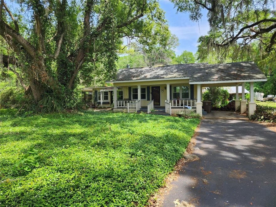 Charming traditional estate in the City - Nestled on 2.2+/- acres within the city limits, this lovely traditional home is surrounded by majestic oak trees and mature landscaping - offering both privacy and natural beauty. Zoned R1, this unique property blends timeless character with modern comfort, featuring 3 bedrooms and 3.5 bathrooms, the home showcases beautiful hardwood, tile, and vinyl flooring throughout. The inviting living room is accented with crown molding and a cozy fireplace, while occasional stained-glass windows cast a warm, welcoming glow. A versatile wood-paneled den serves as the perfect all purposse space. The updated kitchen boasts wood cabinetry, a large pantry, add'l refrigerator, and a spacious dining area with a breakfast bar that comfortably seats 6+/- guests. Appliances include stove, refrigerator, microwave, trash compactor, ice maker, washer, and dryer. Enjoy year-round comfort with gas heat and electric A/C, plus ceiling fans throughout. The welcoming front porch is ideal for gathering with friends and family, while the expansive screened porch opens to a stunning saltwater pool and patio - perfect for entertaining. Add'l features include: security system, inside laundry, back porch, outdoor shower, cook shed for BBQ/ outdoor dining, spacious workshop/electric, charming vintage potting/garden shed, partially fenced yard with dog run, small pond and garden area. This is an opportunity to own a truly special home that radiates warmth, comfort, and character. Appointment only--a must see!!