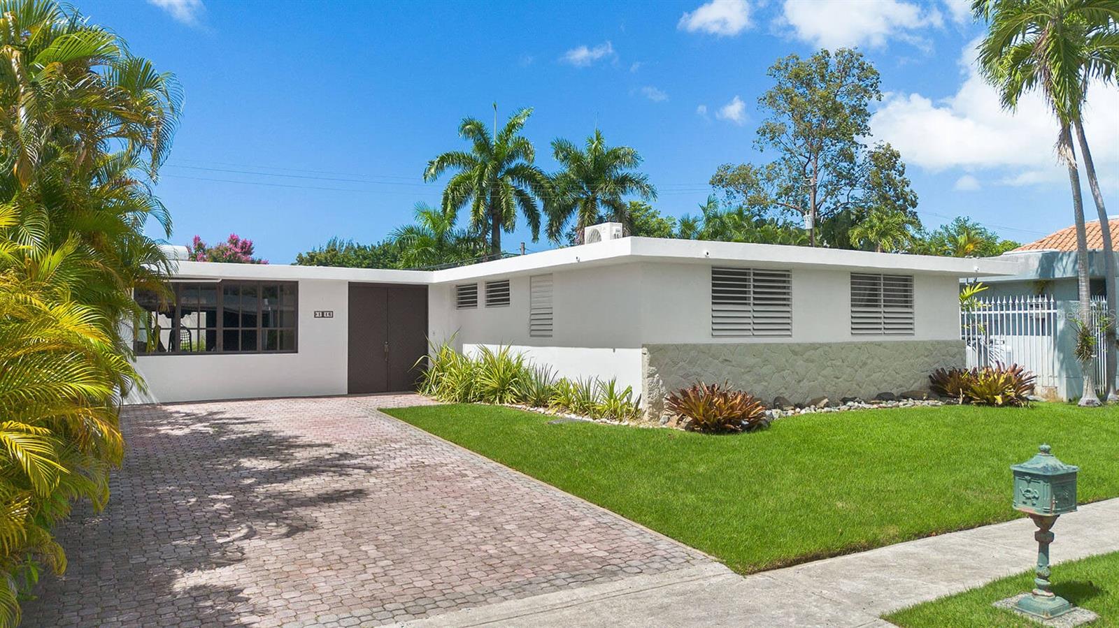 Welcome to a rare opportunity to own a property that offers both charm and potential in equal measure. Set on a generous 603 square meter lot, this residence also enjoys the exclusive benefit of an adjacent remanente land—not deeded, but freely used and appreciated by all surrounding homeowners. Once part of the train's right of way, this bonus green space offers added privacy, serenity, and space to enjoy.
Step into a home that holds true to its original layout and aesthetic, giving you the perfect canvas to personalize with your own updates and renovations.
Outside, enjoy sunny days around the pool, lounge on the open sun deck, or host gatherings on the spacious terrace. A full backup generator ensures year-round comfort and reliability.
Nestled in the heart of Guaynabo, the Torrimar community offers unmatched convenience and accessibility. This centrally located neighborhood is just minutes away from top-rated schools, grocery stores, shopping centers, and a wide range of commercial establishments. Residents enjoy the added benefit of being adjacent to the Torrimar train station, making commuting a breeze.
Right next door is the beloved Torrimar Sports Complex - a vibrant green space featuring extensive sports facilities, a fully equipped gym, and recreational areas for all ages.
Whether you're looking for a peaceful retreat or a place to create your dream home, this property offers an unbeatable combination of location, land, and potential. Make it yours today and bring your vision to life.