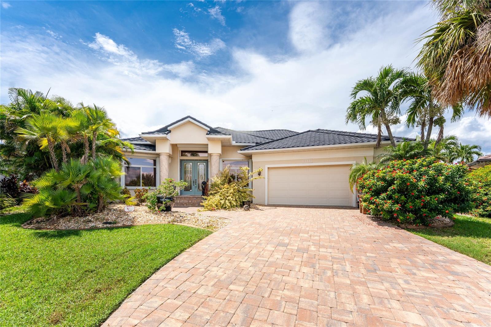 Impressive custom WATERFRONT home built by Towles Construction located on a TIP LOT in desirable Punta Gorda Isles. *New 173 foot seawall* This spacious home offers 3 Bedrooms, Office and 2.5 Bathroom home with attached 2.5 Car Garage. This light and bright home offers an open and split bedroom floor plan with Great Room, formal Dining Room, well appointed Kitchen with Dining area, Media Room and screened Lanai. The Great Room offers disappearing sliding glass doors that open to the Lanai. The Kitchen offers granite counters, wood cabinets, excellent cabinet and counter space, built in oven, 4 burner gas range, desk and closet pantry. The home Office features a built in desk and bookcases.The Master Bedroom suite features Lanai access, oversized walk in closet/dressing room and private bathroom with dual sinks, walk in shower and garden tub. There are two additional generous sized bedrooms and one of the bedrooms has direct access to the guest bath.A half bath is located just outside of the media room and is also a Pool Bath. Continue to the screened Lanai via sliding glass doors with inground pool and attached spa. Continue to the waterfront with concrete seawall (maintained by the cit of Punta Gorda), 45 foot concrete dock and 13,500 lb boat lift. Other features include vaulted ceilings, cathedral ceilings, hurricane protection, irrigation system. **NEW ROOF 2023** There is NO HOA and the utilities are city water and sewer. This home is minutes from historic downtown Punta Gorda shopping, dining, medical care, waterfront parks, art galleries, walking and biking paths, Charlotte Harbor Event Center, boat ramps, fishing piers, weekend farmer and artisan markets, downtown events and more!