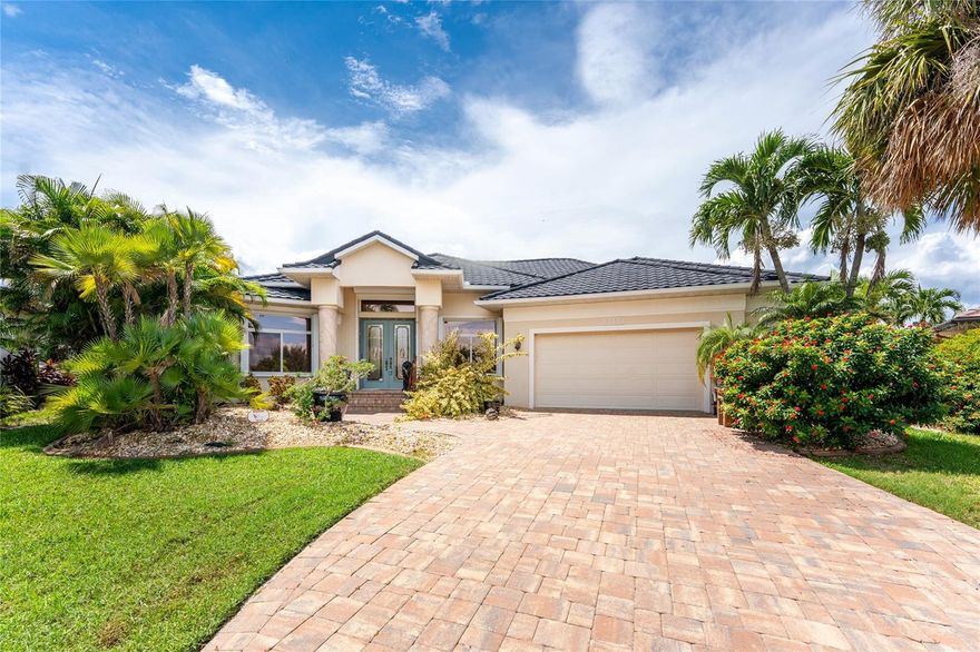Impressive custom WATERFRONT home built by Towles Construction located on a TIP LOT in desirable Punta Gorda Isles. *New 173 foot seawall* This spacious home offers 3 Bedrooms, Office and 2.5 Bathroom home with attached 2.5 Car Garage. This light and bright home offers an open and split bedroom floor plan with Great Room, formal Dining Room, well appointed Kitchen with Dining area, Media Room and screened Lanai. The Great Room offers disappearing sliding glass doors that open to the Lanai. The Kitchen offers granite counters, wood cabinets, excellent cabinet and counter space, built in oven, 4 burner gas range, desk and closet pantry. The home Office features a built in desk and bookcases.The Master Bedroom suite features Lanai access, oversized walk in closet/dressing room and private bathroom with dual sinks, walk in shower and garden tub.  There are two additional generous sized bedrooms and one of the bedrooms has direct access to the guest bath.A half bath is located just outside of the media room and is also a Pool Bath. Continue to the screened Lanai via sliding glass doors with inground pool and attached spa. Continue to the waterfront with concrete seawall (maintained by the cit of Punta Gorda), 45 foot concrete dock and 13,500 lb boat lift. Other features include vaulted ceilings, cathedral ceilings, hurricane protection, irrigation system. **NEW ROOF 2023**  There is NO HOA and the utilities are city water and sewer. This home is minutes from historic downtown Punta Gorda shopping, dining, medical care, waterfront parks, art galleries, walking and biking paths, Charlotte Harbor Event Center, boat ramps, fishing piers, weekend farmer and artisan markets, downtown events and more!