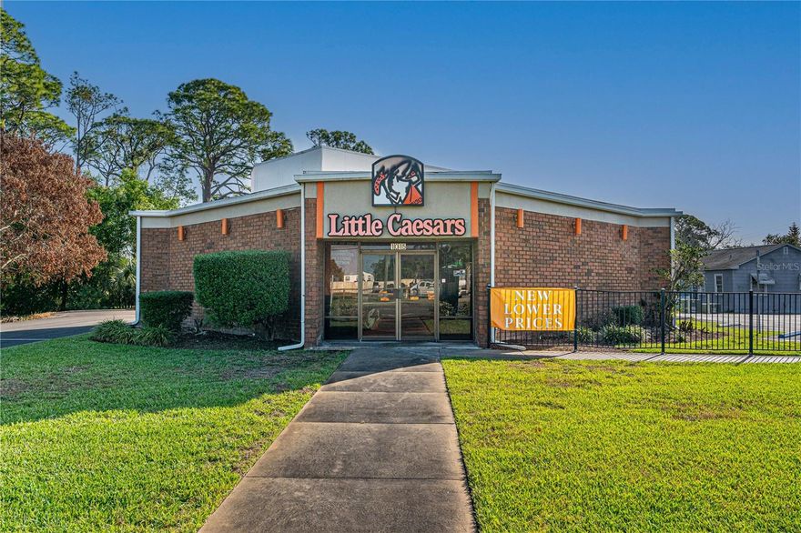 Opportunity to acquire income-producing investment with a solid lease already in place with a recognized national chain take-out restaurant. Whether you’re an investor seeking investment returns or looking to add a low-maintenance asset to your portfolio, this property delivers strong fundamentals: high-traffic location, quality construction, and a proven national tenant already in place. Located on high-visibility corner lot on US-1 / Ridgewood Ave – one of the busiest corridors in the area with an Annual Average Daily Trip (AADT) of 27,000 and excellent accessibility with a bi-directional median cut. Low maintenance brick commercial building on a corner lot that is nicely landscaped with underground utilities and a newly resurfaced parking lot. The sale includes the building and both parcels with approximately 200’ of Ridgewood Ave. frontage. The active lease is fully transferable, providing income cash flow with a nationally recognized tenant. The business operations, equipment, and inventory are owned by the restaurant and are not included in the sale. Information is assumed accurate but not guaranteed. Measurements are approximate. Buyers and their agents must verify all information that is important to them.