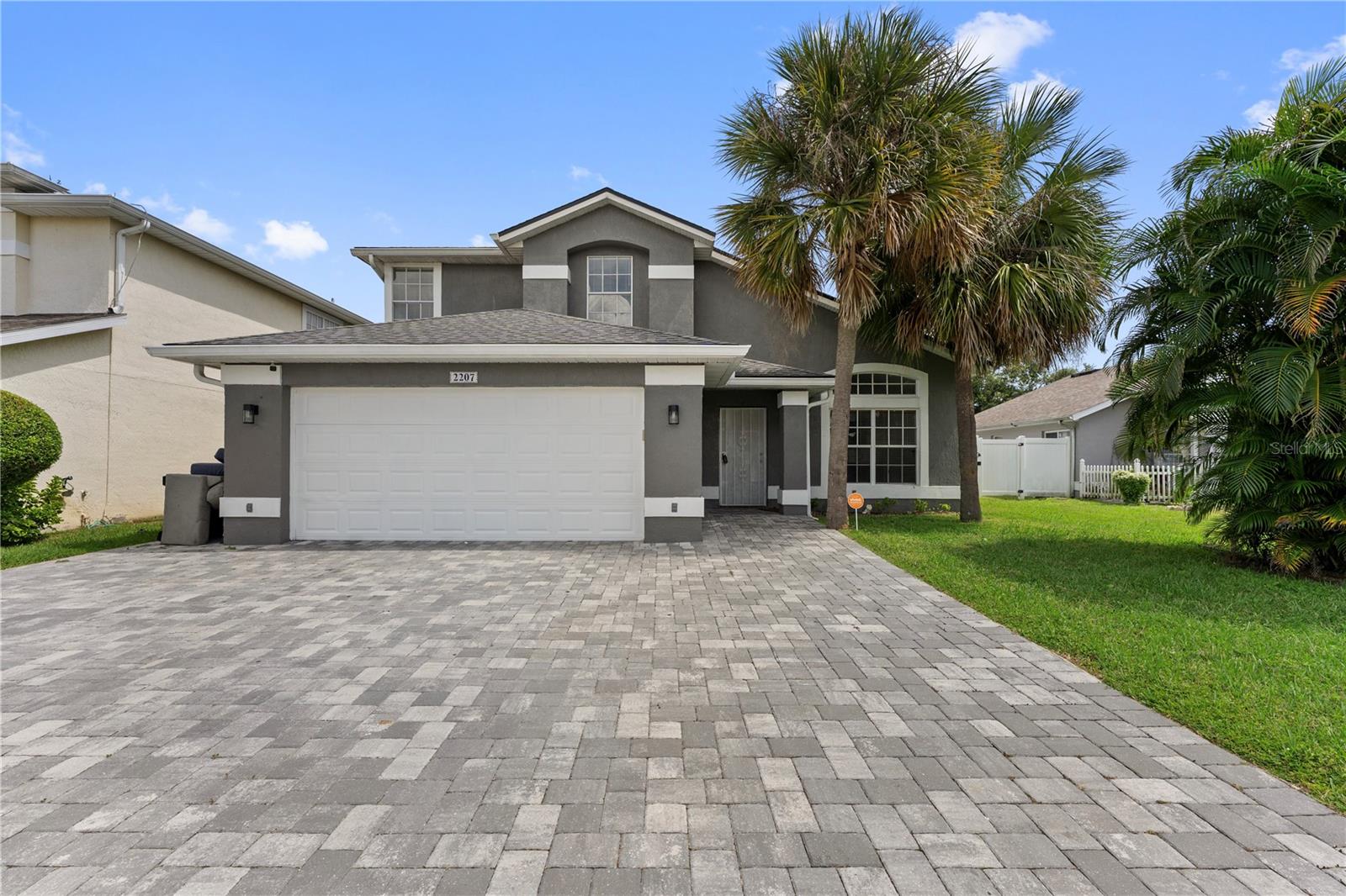 Beautiful well kept, 4-bedroom, 2.5-bathroom home in the heart of Kissimmee! Featuring a modern open-concept design, this home boasts high ceilings, stylish laminate flooring, and a stunning kitchen with quartz countertops, blue accent island, backsplash, and stainless steel appliances. The spacious main living area is flooded with natural light and opens directly to a fenced-in backyard with a concrete patio and cozy fire pit, perfect for relaxing or entertaining. The primary suite is located on the main floor for added privacy, while the remaining bedrooms are upstairs, along with a full bath featuring dual sinks. Conveniently located near shopping, dining, schools, and major highways, with easy access to the Florida Turnpike, Orlando International Airport, and Lake Nona Medical City.