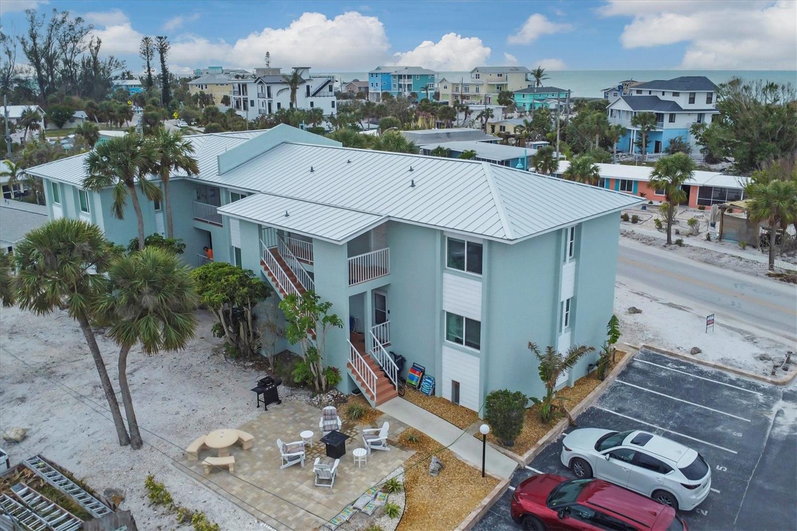 BEACH LIFE IS WAITING FOR YOUR AT HOLIDAY CONDO located 1000 feet from the deeded beach access!! Here is your opportunity to own a beautiful, 2 bedroom / 1 bath condo (with dual access and 2 sinks) on the first floor with peek a boo views of the Gulf of Mexico. This gorgeous unit is offers a new roof, new ac and water heater (2024) vinyl and tile flooring throughout. The beach frontage on Manasota Key is beautiful for morning strolls and enjoying breathtaking sunsets. Directly in front of the unit is a personal parking space. Laundry closet is off the open front porch. As an investment property, you can have the potential to cover your property taxes, annual maintenance / HOA fees, and generate extra income, while enjoying the property yourself. Take a short beach walk along the gorgeous Gulf of Mexico to the restaurants and live entertainment at Englewood Beach. YOUR PERFECT WINTER ESCAPE AWAITS! Schedule your private showing today!