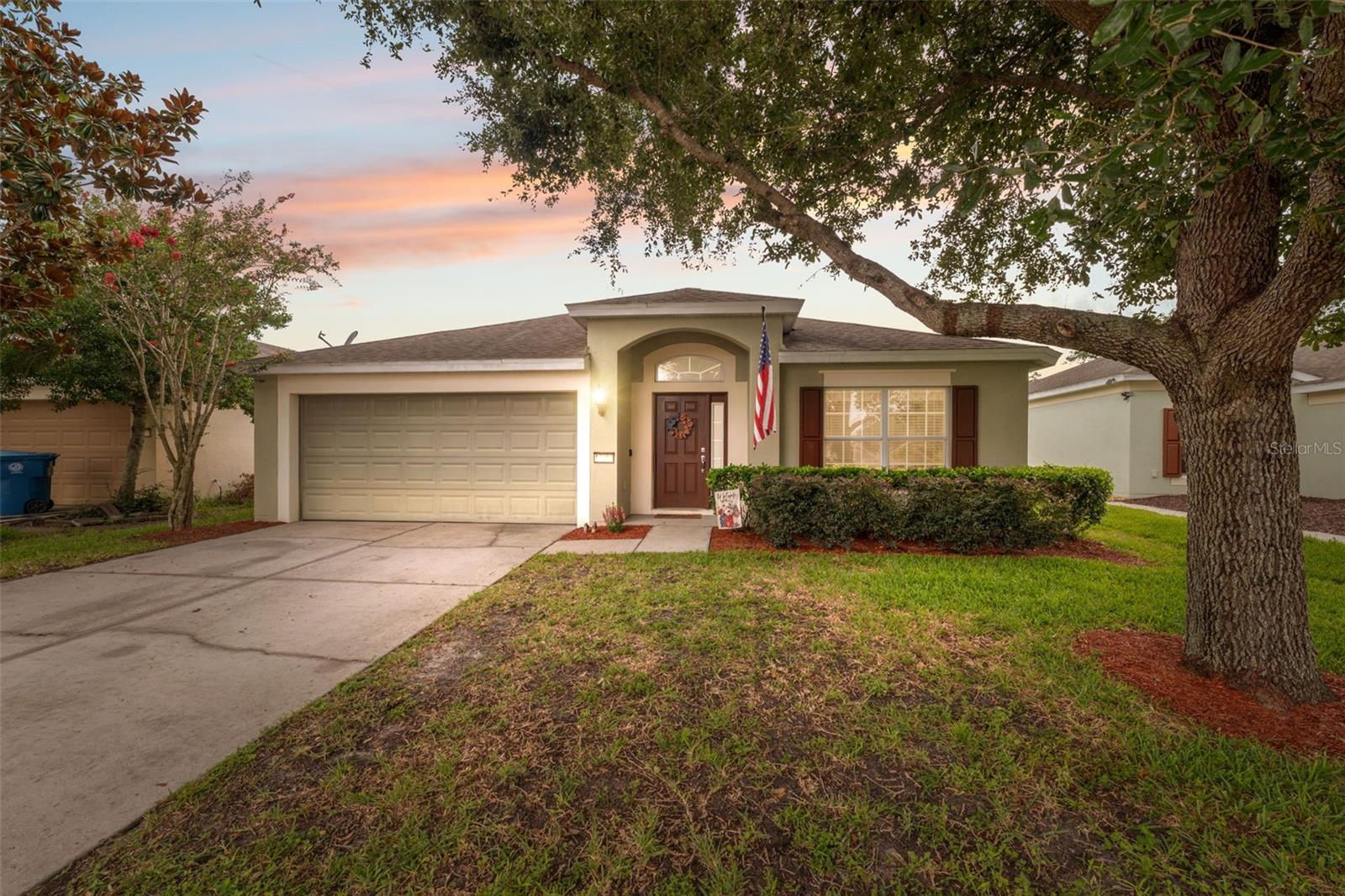 Nestled in the sought-after Trillium community, this well-appointed home features 3 bedrooms, 2 bathrooms, and a spacious 2-car garage. A welcoming covered front porch leads you into a bright living room with vaulted ceilings and stylish ceramic tile flooring that mimics the look of natural wood planks. Just beyond the living room, separated by a wall for added privacy and functionality, you'll find a spacious kitchen, dining, and family room combination. The kitchen is outfitted with Corian countertops, black appliances, a breakfast bar, and a stunning wall of sliding glass doors that open to a screened-in lanai—creating a serene spot to enjoy your morning coffee or unwind in the evening breeze. Tucked away at the rear of the home, the primary suite boasts an impressively large 7x12 walk-in closet and a luxurious ensuite bath with Corian counters, dual vanities, a deep soaking tub, a step-in shower, and a private water closet. Two additional bedrooms offer built-in closets and share a full bathroom with a tub/shower combo. The Trillium community enhances everyday living with well-maintained sidewalks throughout, a resort-style pool with ample lounging space, a playground, and open green spaces ideal for walking dogs or enjoying outdoor activities with friends and neighbors. Conveniently located just 2 miles from the Suncoast Parkway (589), this home offers an easy commute to Tampa and surrounding areas while maintaining a quiet, residential feel. Area highlights include Weekiwachee Springs State Park, just 12 miles away, known for its clear springs, kayaking, and natural beauty; Hernando Beach, approximately 17 miles west, perfect for waterfront dining and sunset views; and Brooksville’s historic downtown district, only 9 miles away, offering boutique shops, local restaurants, and year-round community events.