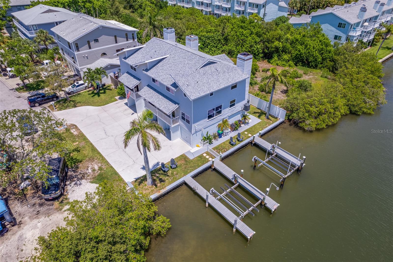 Presenting a rare and unique waterfront townhome duplex! Two units. This extraordinary townhome duplex offers two luxurious units encompassing over 6,500 total square feet. Boasting six spacious bedrooms, six full baths and two half baths, this property is an exceptional blend of comfort and elegance. Each unit includes its garages, totaling six, ideal for residents and guests, with plenty of additional guest parking. The property sits on an approximately 7,000-square-foot lot and enjoys a private location at end of the street. The primary residence is approximately 2,700 square feet and features four bedrooms, 4.5 baths, two balconies with outdoor seating and a dining table, scenic water views, a four-car garage and an outdoor shower. The secondary residence offers approximately 1,300 square feet with two bedrooms, two baths, two balconies and a two-car garage. This flexible property offers the option to live in one unit while renting out the other to offset costs or potentially live mortgage-free. It's an ideal setup for homeowners seeking a primary residence with income-generating potential.Completely renovated and meticulously furnished and decorated, this turnkey property is operating as a successful vacation rental with no minimum rental restrictions. It has a history of rental income and impressive potential future bookings in place, making it a prime investment opportunity. On a desirable Intracoastal waterfront piece of land, the property features a private dock with two boat slips and lifts, offering seamless access to the water. In addition, it is just two blocks from a beach access to the pristine sands of the Gulf of Mexico. You will enjoy the best of both coastal worlds. This home is fully equipped for fun and relaxation, featuring kayaks, bikes, cornhole, ping pong, beach toys, chairs, fishing poles and more. Whether you’re hosting guests or enjoying a private retreat, everything you need is at your fingertips. Near charming shops, boutiques, popular restaurants and vibrant pubs, this location is ideal for exploring local treasures. Enjoy daily sunsets, world-class shelling, fishing, paddle boarding and snorkeling, all nearby. Don’t miss this unparalleled opportunity to own a one-of-a-kind waterfront duplex with unbeatable amenities and income potential.