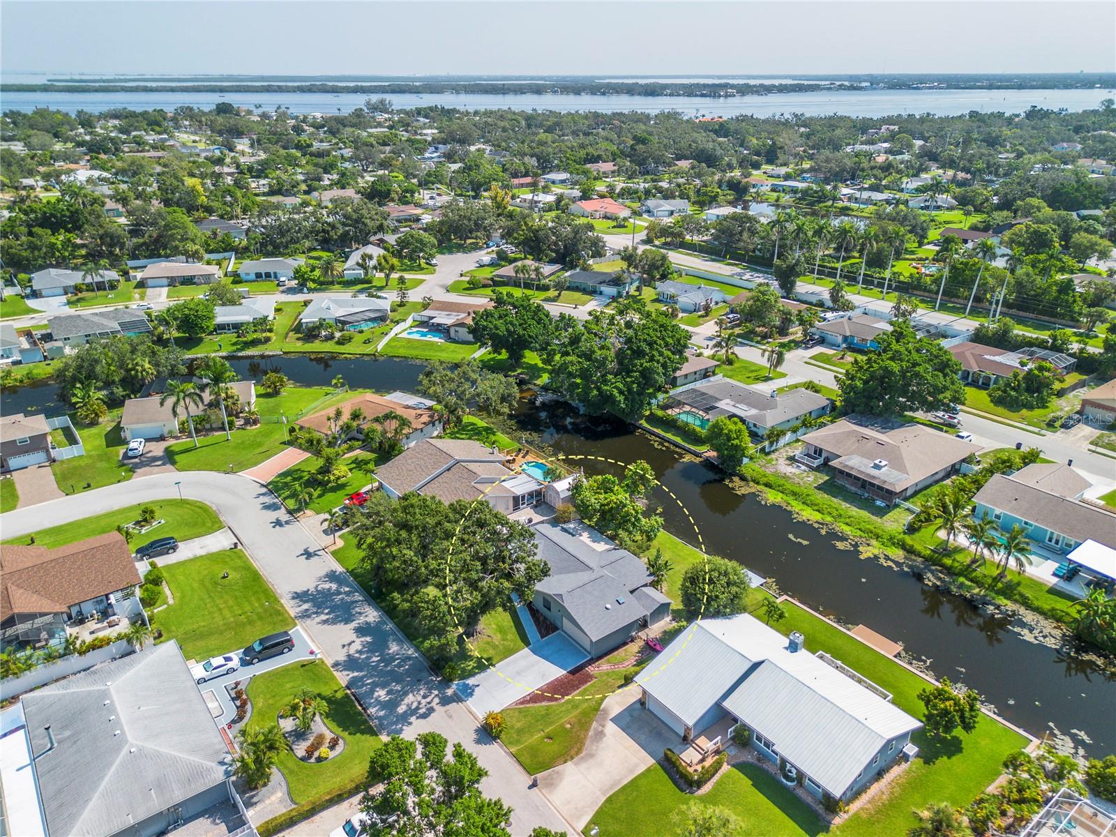 Cuter than a button Tudor style house in a highly sought after quiet and well-established neighborhood in an ideal Florida location as it is minutes from the beaches, the intercoastal and Robinson's Preserve. This house was built for a retired couple or a small family, and it is ideal for a vacation cottage or a real estate investor. Enjoy the Florida mornings and or evenings from the oversized backyard that sits on a large canal style pond where you can fish for Florida Bass from the dock or from your private kayaks. The bright and airy kitchen has oak cabinets throughout and provides access to the rear deck through atrium doors and features a full height pantry. The rare brick wood burning fireplace in the living room overlooks the dining room. Plenty of storage in the oversized 2 car garage and detached shed. The roof has a 50 year warranty and is newly installed in 2023. The AC is newer as it was installed in 2022 and the electrical panel was just replaced. A partial remodel was done in 2016 updating the kitchen and bathroom 2. Enjoy serene and private lagoon views, with abundant wildlife right from your backyard. Move-in ready and packed with upgrades—don’t miss this incredible opportunity! Exceptional freedom, prime location, and effortless coastal living await. With no deed restrictions and an optional HOA, this property offers unparalleled flexibility — whether you envision a private home, seasonal retreat, or an exclusive vacation rental opportunity, the choice is yours. This home is situated near some of the area's finest outdoor treasures, you’ll enjoy close proximity to Robinson’s Preserve, offering over 3 miles of scenic hiking trails and kayak adventures, as well as DeSoto National Park, G.T. Bray Park’s premier sports facilities, and the natural beauty of Perico Preserve and Bishop Point Park. In just 5 minutes, find yourself basking on the world-renowned beaches of Anna Maria Island, indulging in boutique shopping, fine dining, and vibrant coastal entertainment. This distinguished location also provides easy access to top-tier medical facilities, the Sarasota/Bradenton International Airport, and the cultural and economic hubs of the Tampa/St. Pete Metro Area — all within a 30–45 minute drive. This is a rare opportunity to embrace an elevated Florida lifestyle — schedule your private tour today!!