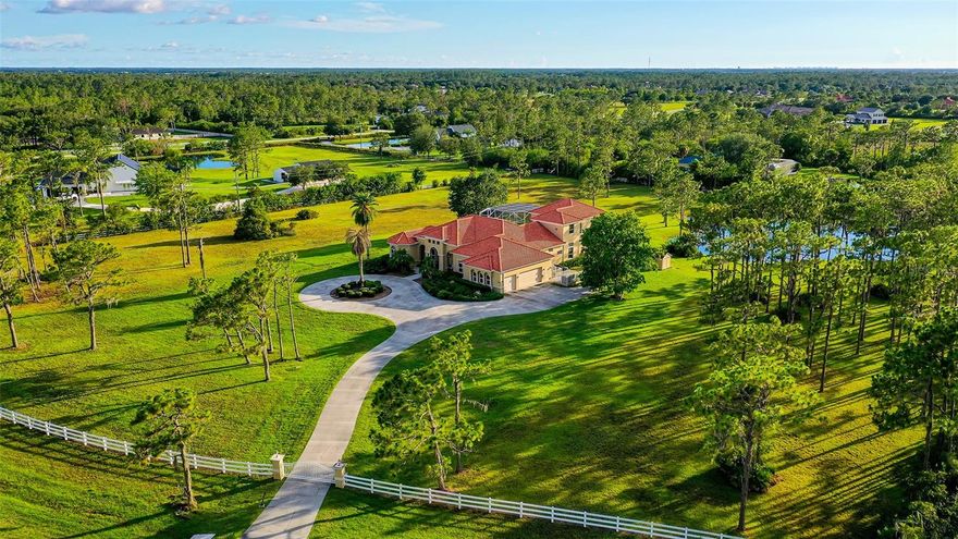 Welcome to Foxwood at Panther Ridge, an equine-friendly community where privacy meets a remarkable lifestyle. As the private gate opens to reveal this 6.73-acre estate, you'll be enchanted by the property's natural beauty. The Mediterranean-style custom pool home boasts top-tier, fortress-like construction and offers ample parking along the winding circular drive and in the three-car garage.

Step inside to be greeted by a breathtaking view of the expansive screened patio, which features a large heated swimming pool, spa, and outdoor kitchen equipped with a Lynx grill. This impeccably maintained home showcases a neutral palette, abundant natural light, 12-foot ceilings, a whole-house generator, and numerous custom details.

Ideal for entertaining, the spacious wet bar connects the living room and chef's kitchen, featuring a sink, generous counter space, cabinet storage, and a beverage cooler. The chef's kitchen is equipped with Subzero and GE appliances, as well as an oversized walk-in pantry. Adjacent to the living room is a generous home office designed with two custom-built workstations.

The palatial master suite occupies the front corner of the home, offering a bedroom with views of the backyard and pool, along with a luxurious bathroom that includes a large tub and an expansive shower with enhanced water pressure from both showerheads. The main level also features three additional bedrooms, three full bathrooms, and a spacious laundry room.

Upstairs, you'll find a bonus room and another bedroom with an en-suite bathroom, plus a second screened patio overlooking the pool. The outdoor space is equally impressive, featuring your own private stocked pond and a generous lot that offers a blank canvas for your dream oasis—whether that includes horse stables, a barn, or sports courts.

Panther Ridge boasts no CDD fees, a low HOA fee, and A-rated schools. Community amenities include a playground, basketball court, sports field, and park pavilion, along with an extensive network of trails for hikers and riders. Plus, you’re just minutes away from the vibrant shops and restaurants of Lakewood Ranch and UTC, surrounded by award-winning golf courses, and a short drive to the pristine beaches of Lido Key and Anna Maria Island.

This home perfectly combines exceptional features with a prime location—exactly what you’ve been searching for!