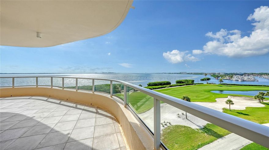 Immerse yourself in luxury with this exceptional Antigua residence at Grand Bay, perched on the corner of Building III and offering sweeping panoramic views of Sarasota Bay, Harbourside Golf Course, the marina, and the shimmering downtown skyline. This nearly 3,000-square-foot residence is a sunlit, expansive retreat, perfectly designed for comfort. The convenience of a residents-only elevator transports you from the secure, under-building parking area directly to your private foyer. As you enter, the grandeur of floor-to-ceiling glass sliders draws your attention to the expansive wraparound terrace, where breathtaking vistas create a captivating backdrop. The interior offers a neutral palette, enhancing the light-filled ambiance and seamless flow throughout the space. Travertine tile flooring connects the formal dining area and living room, complete with a wet bar, providing a perfect setting for entertaining. The eat-in kitchen, bathed in southern light from glass sliders leading to a secondary terrace, features an island, double built-in ovens, and a charming dining nook—ideal for savoring the stunning views. The primary suite, positioned in the northeast corner for ultimate privacy, serves as a serene sanctuary. It opens to the large bayfront terrace, offering a personal escape with expansive water views. The suite includes dual bathrooms and a generously sized walk-in closet. Two additional guest bedroom suites, one currently configured as a den, are thoughtfully arranged in a split plan to ensure a tranquil environment for visitors. Grand Bay is nestled within the prestigious Bay Isles community on Longboat Key, blending exclusivity with convenience. Residents benefit from on-site management, security, and a 24-hour manned guard gate. The resort-style amenities elevate your lifestyle with a state-of-the-art fitness center, professional-grade tennis courts, and a bayside sundeck equipped with lounging and dining areas. Enjoy a refreshing swim in the heated pools, relax in the spa, or gather for a barbecue at the designated grill stations. The lively clubhouse offers a variety of engaging activities, and deeded access to the private Bay Isles Beach Club is just a short bike ride away, completing the exceptional living experience.
