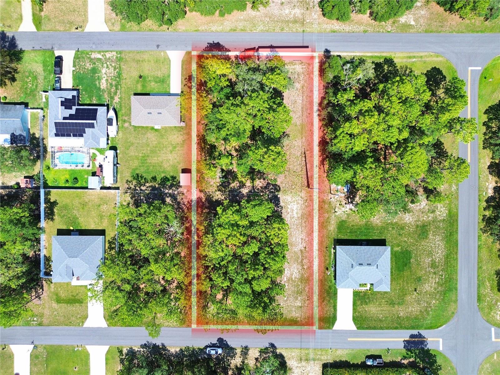 Located Southwest of Ocala (Marion County), this spacious 0.75-acre lot (132 x 249) is a rare find in the Marion Oaks community where larger parcels are limited. Zoned R1 for single-family residential use, the property lies in Flood Zone X, meaning flood insurance is typically not required. Surrounded by new construction, the lot offers close proximity to electrical access and public water is available—just not yet connected. A prime opportunity to build in a rapidly growing community with solid infrastructure and easy access to I-75. Coordinates: 29.00246486, -82.20461691. Parcel #8009-0000-03. 2024 property taxes: $106.72. The property is currently designated as a greenbelt tract on the original subdivision plat, but is surrounded by established homes and has potential to be replatted as a buildable lot with county approval.