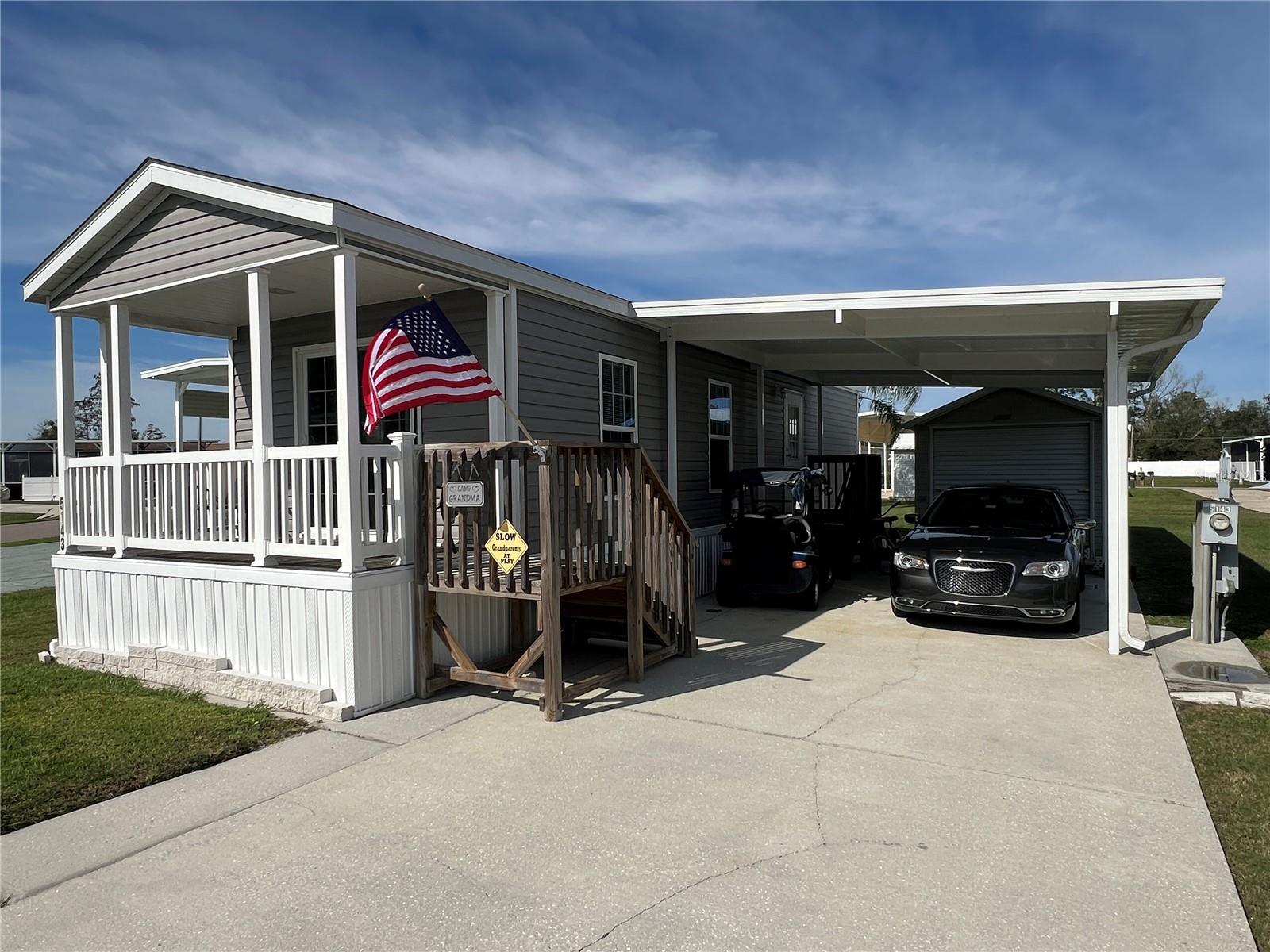 Come and explore this exquisite Live Oak Manufactured Home in Phase 4 of Mount Olive Shores. Built in 2019, this fully furnished home includes a carport, all major appliances, ceiling fans, and window treatments. You'll also enjoy a 200-square-foot air-conditioned shed with a washer & dryer and additional storage space. As a special bonus, the sellers are including a Club Car Golf Cart, perfect for navigating the community. The concrete pad can accommodate any length motorhome and features all public utility hookups. The annual HOA fee covers basic lawn and common area maintenance. Mount Olive Shores is a welcoming and secure gated community, conveniently located just 3.5 miles from I-4, various shopping outlets and malls, renowned medical facilities, Tampa and Orlando International Airports, and Central Florida attractions, all within an hour's drive. Please note that this is a Class A motorhome, deed-restricted community, requiring ownership of a Class A motorhome in the first year of residency.