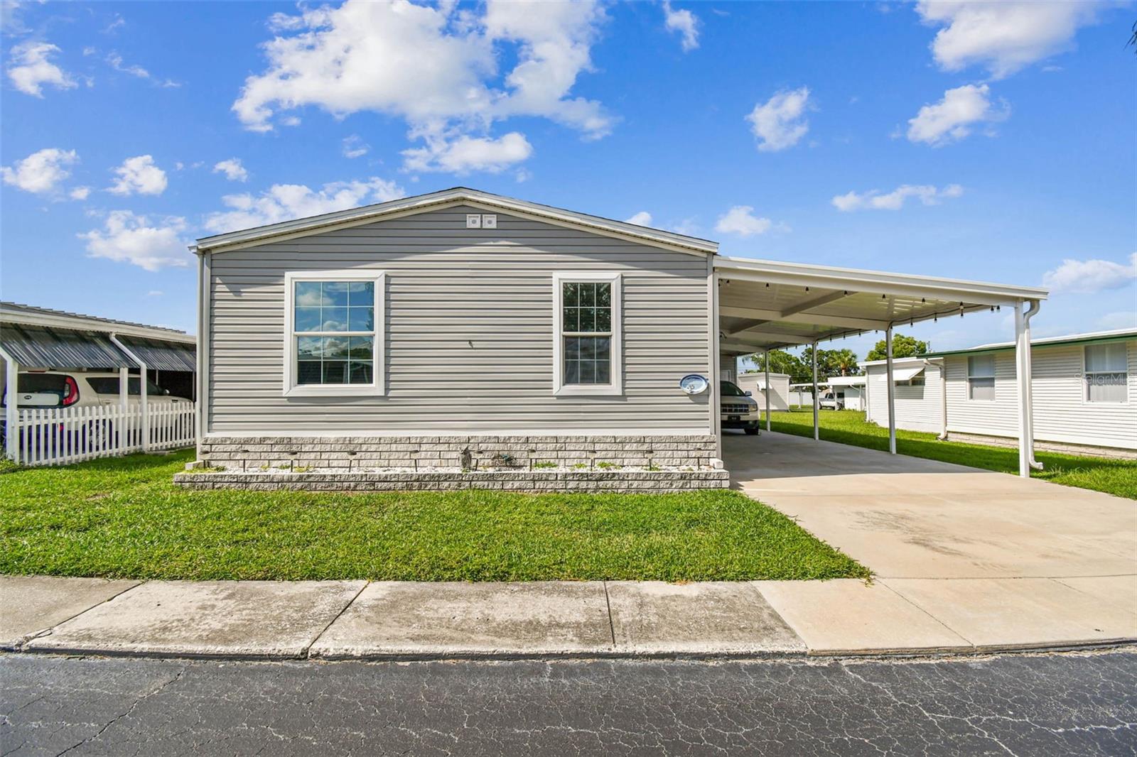 Stunning 3-Bedroom 2017 Manufactured Home in the Pointe West 55+ Community – Coastal Vibes with Designer Touches makes this Furnished home MOVE IN READY!
Step into this light and bright 3-bedroom, 2-bath manufactured home that perfectly blends style, comfort, and functionality. From the moment you enter, you’ll notice the high ceilings, crown molding, chair rail, and custom lighting that add an elegant touch throughout.
The spacious ktchen is a true centerpiece with tons of counter space, abundant cabinetry, and a cozy nook ideal for a crafting area or home office. An inside laundry room adds convenience, while the showstopper dining area features a custom table and high-end designer furnishings that make entertaining effortless.
Enjoy the coastal, Key West-inspired vibe in the bedrooms, designed with comfort and charm in mind. The primary bedroom has an ensuite bathroom with walk in shower and double vanity. The Tommy Bahama inspired furniture in this bedroom is just another added feature that adds the impressive furnishings throughout.
Outdoors, the home boasts an impressive 16 ft wide, 3-car carport with golf cart parking, plus an oversized storage area with double doors—perfect for motorcycles, golf carts, or workshop space.
Located in a welcoming 55+ community, you’ll enjoy resort-style living with amenities, social events, and the relaxed Florida lifestyle you’ve been dreaming of. So Get Ready The Beach is Calling.. Just minutes to our Sugar Sand Beaches, Dining, Lake Seminole, and so much more. Affordable Florida Living at $300 month including Water, Trash, LawnCare and all the amenties... including private access to Lake Seminole.