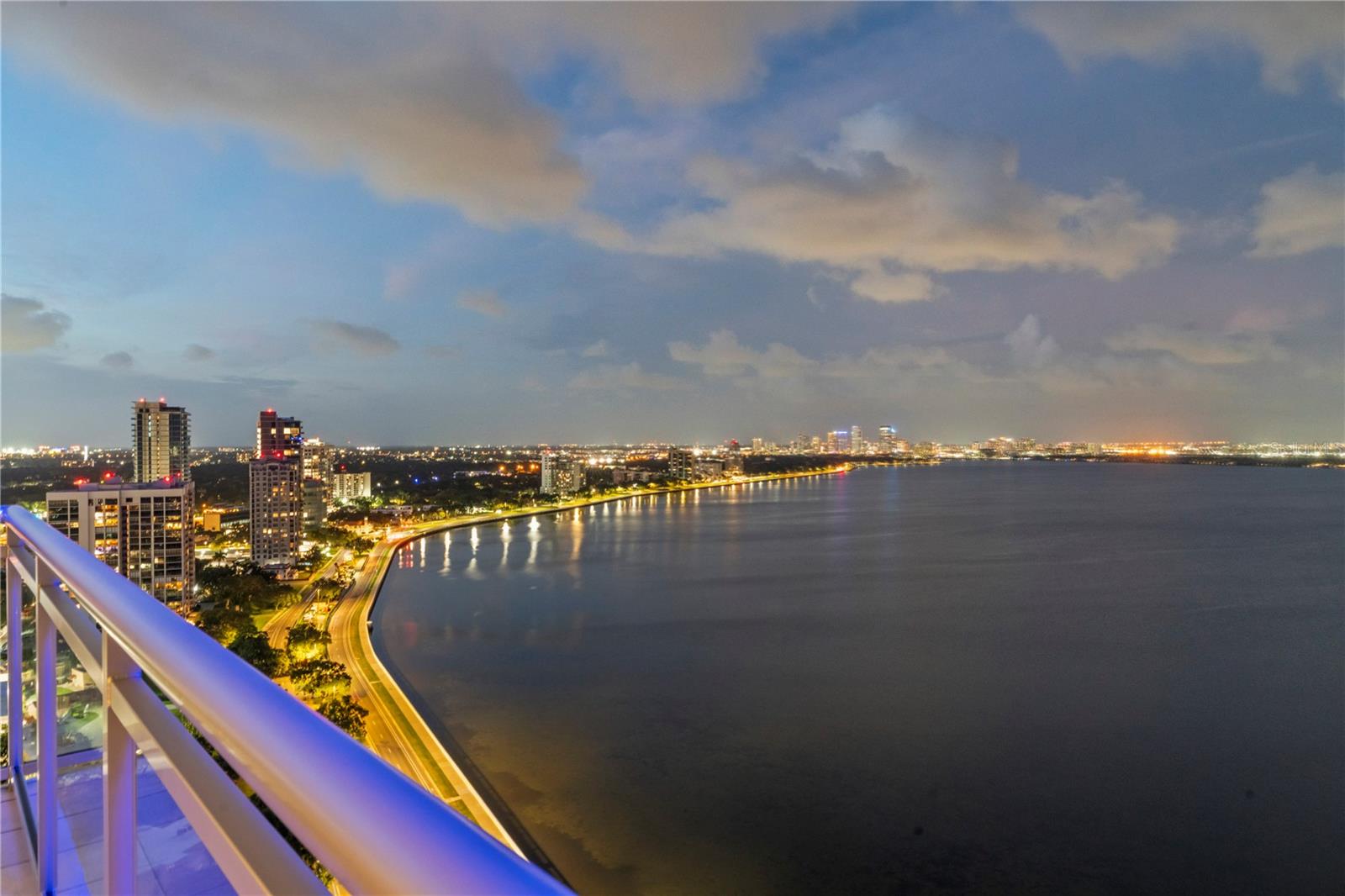 Incredible opportunity to own the prestigious Penthouse at the most sought after building on Bayshore Blvd, The Virage! This "Home in the Sky" encompasses the entire top floor with 6801 square feet of air conditioned space and 360 degree views plus multiple large balconies giving you endless views. Step off the private elevator into your foyer featuring two Louis Poulsen Artichoke Chandeliers, a floor to ceiling window on one end and double doors on the other. Upon entering the large open living space you are enveloped in some of the most jaw dropping water views of Hillsborough Bay with Tampa's downtown skyscrapers as the backdrop. The night view with the twinkling lights of the buildings reflecting off the water is just majestic! The living area of the home is large and open and can be used in very flexible ways depending on your lifestyle. The kitchen has gorgeous custom cabinetry with more than ample space, a Wolf range, separate Sub Zero refrigerator and freezer columns, a walk-in pantry behind a hidden door and an outdoor GAS GRILL on the balcony. The large open living spaces are perfect for entertaining and nearly every space opens to an oversized balcony that can accommodate multiple sitting areas, lounge chairs, and outdoor dining. Situated off of the living room is a stunning onyx stone built-in bar with 3 large wine refrigerators. Walking past the living room and bar you enter a beautiful gallery perfect for displaying art. Located off of the gallery are 3 en-suite bedrooms plus the primary suite and the large very high end custom built theater with top of the line equipment. The primary suite is truly fit for a king and a queen and features a large bedroom with a sitting area, a huge bathroom with walk-in shower and a tub overlooking the lush green treetops of South Tampa and views all the way to Tampa Bay, a beautifully built out closet for him and one of the biggest closets for her in any home plus a dressing room and make up area with windows for natural light. This home also features an enormous amount of air conditioned storage plus a private oversized 3 car garage with garage doors. This is truly a one of a kind property that you won't want to miss!