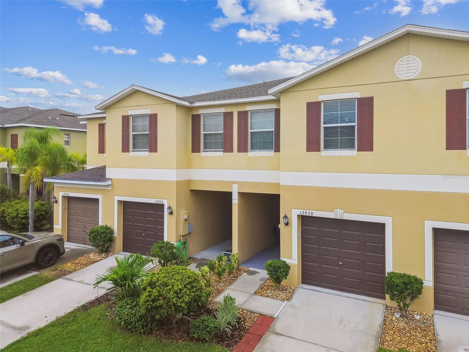 SERENE POND VIEWS! MAINTENANCE FREE LIVING! INCREDIBLE LOCATION! Welcome home to this BEAUTIFULLY MAINTAINED 3 bedroom + LOFT, 2.5-bathroom townhome with one-car garage offering 1,668 square feet of stylish living space. Recently built in 2017 with thoughtful upgrades, move-in-ready features and many amazing community amenities to enjoy! Step inside and feel right at home in the spacious great room featuring ceramic tile flooring, soaring ceilings, neutral color palette, and open layout that feels both bright and inviting. The kitchen is a showstopper with rich cabinets, crown molding, recessed can lighting, closet pantry, and convenient breakfast bar with adjoining dining space. All appliances stay!! Sliding glass doors lead outside to the covered, screened-in lanai with peaceful pond views making this a perfect place to relax and unwind after work or a great place to start your day. Downstairs also features a convenient half bathroom that is perfect for guests and handy storage closet. Upstairs, you’ll find 3 bedrooms along with a versatile loft and laundry closet all featuring BRAND NEW CARPET! The spacious primary suite features serene views of the backyard pond and offers a walk-in closet and a private bath with dual sinks and shower. Secondary bedrooms share a bathroom and are conveniently separated from the primary suite by the multi functional loft! This home is NOT in a flood zone and has hurricane shutters for added peace of mind! There’s NO CDD here! Low HOA includes reserves for roof replacement, exterior paint and grounds maintenance! Enjoy access to the Summerfield amenities with so much to enjoy: two pools, playground, dog park, tennis courts, pickleball courts, sand volleyball court and basketball courts! Excellent Riverview location offers grocery stores and restaurants within walking distance! Hospitals, school and shopping are all nearby along with quick access to I-75 for easy community to Tampa.